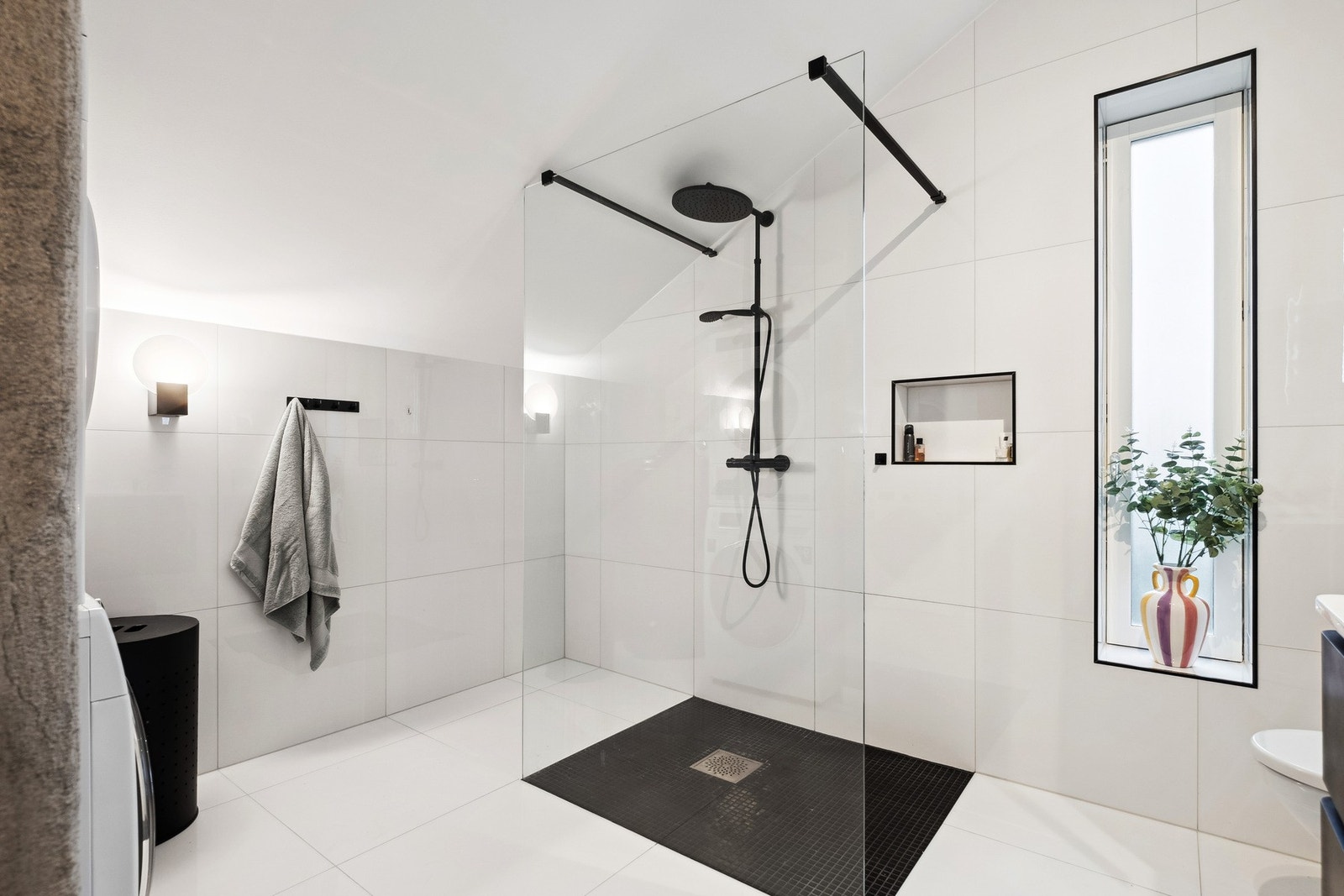 På badet finner du flotte detaljer som en herlig tropedusj og en praktisk innfelt hylle for dusjartikler. Galleribilde