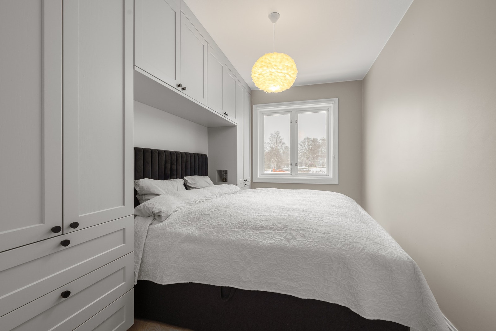 Innbydende hovedsoverom med plassbygd garderobeløsning fra Bærum Kjøkken som ramme rundt sengen. Galleribilde