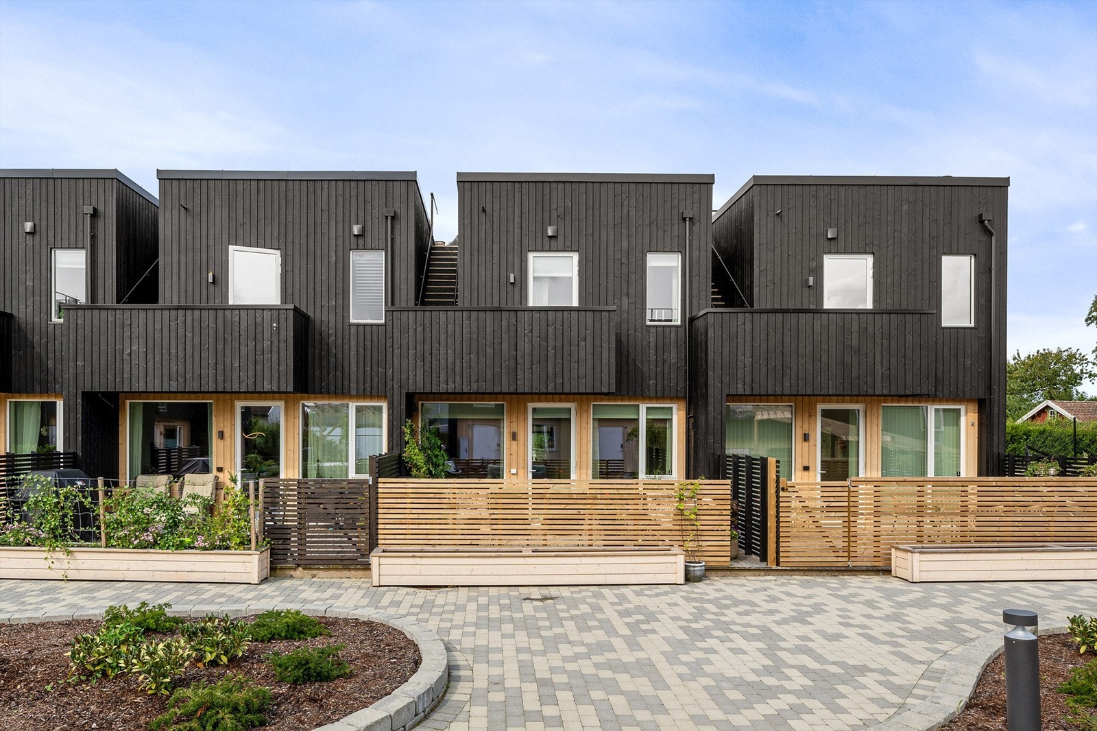 Et moderne arkitektonisk uttrykk på fasader og utomhusanlegg. Galleribilde