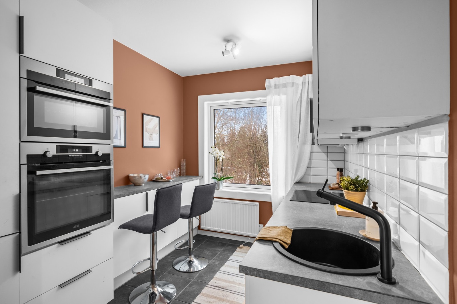 Innredningen har hvite, glatte fronter med en benkeplate i laminat. Galleribilde