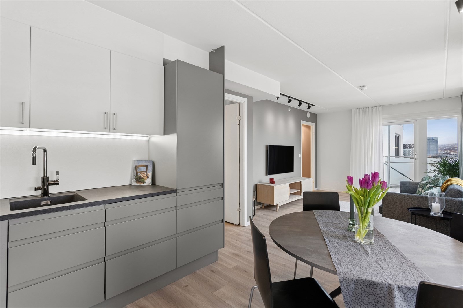 Leiligheten har en sosial, åpen stue- og kjøkkenløsning. Galleribilde