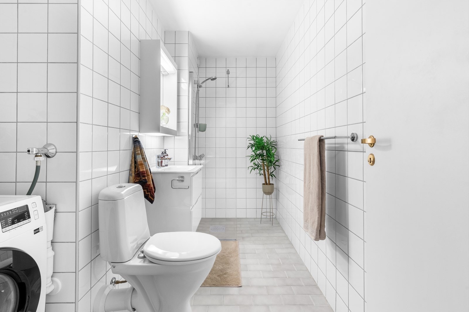 Baderommet er originalt fra byggeår med hvite fliser på vegger og lysegrå vegger på gulvet. Galleribilde