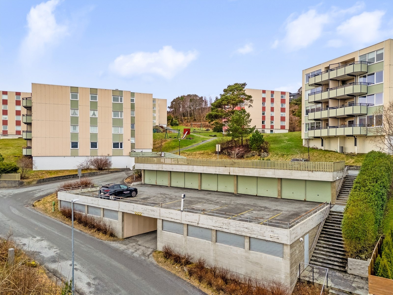 Medfølgende garasjeplass (i rekke) på nedsiden av bygget Galleribilde