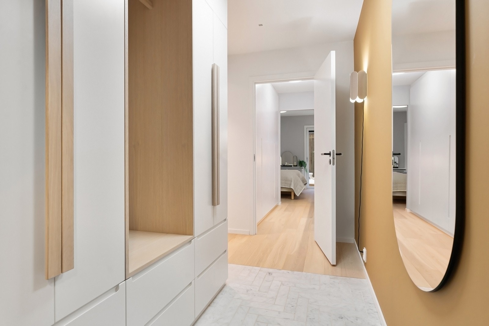 Innbydende entré med fantastisk marmorgulv lagt i fiskeben, og garderobeskap bygget av møbelsnekker for optimal oppbevaringsplass Galleribilde