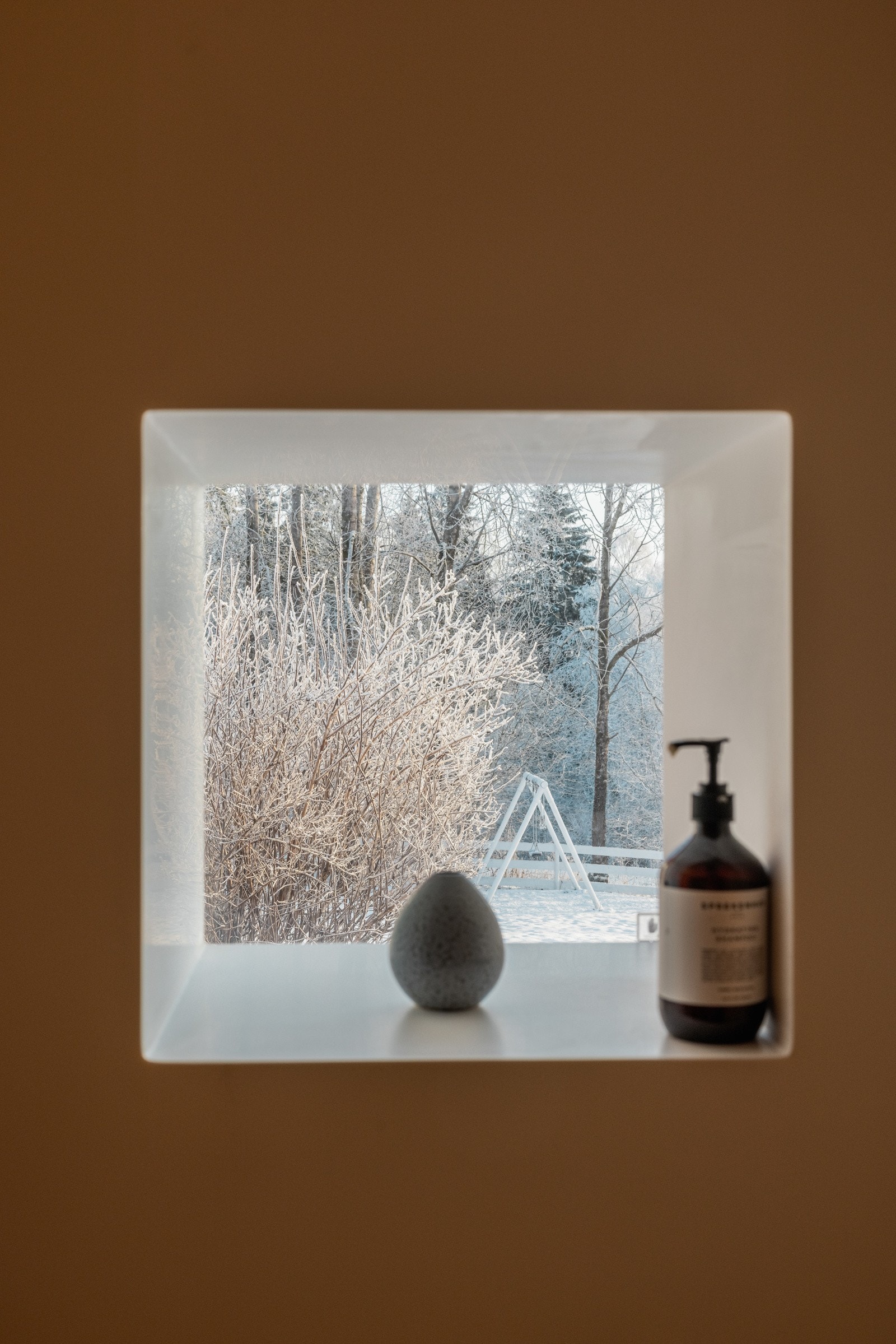 Baderomsinnredningen byr på servantskap med glatte og heldekkende servant. Speil med lysarmatur på vegg over servant. Galleribilde