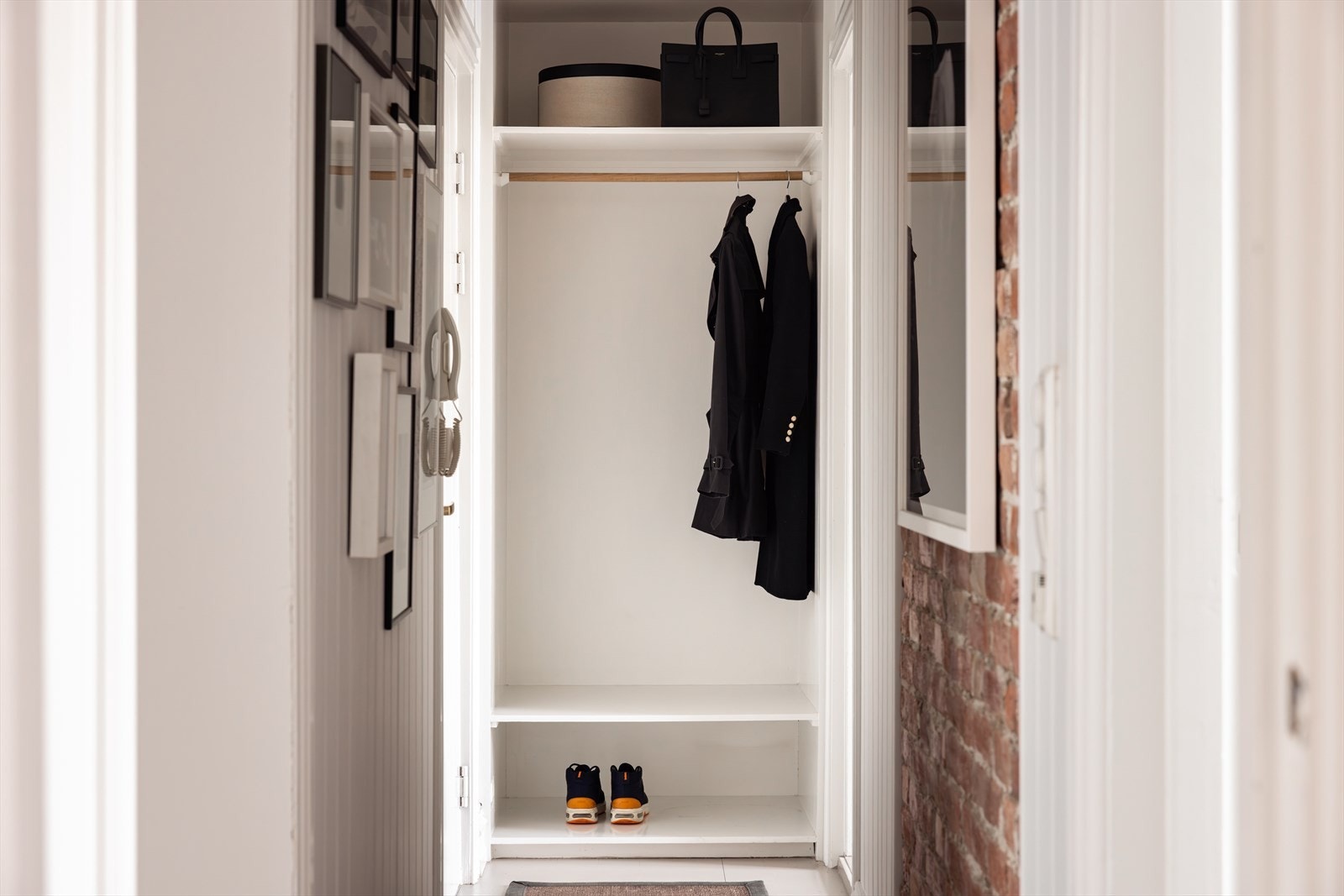 Lys gang med plass til å henge fra seg tøy, og sette fra seg sko. Galleribilde