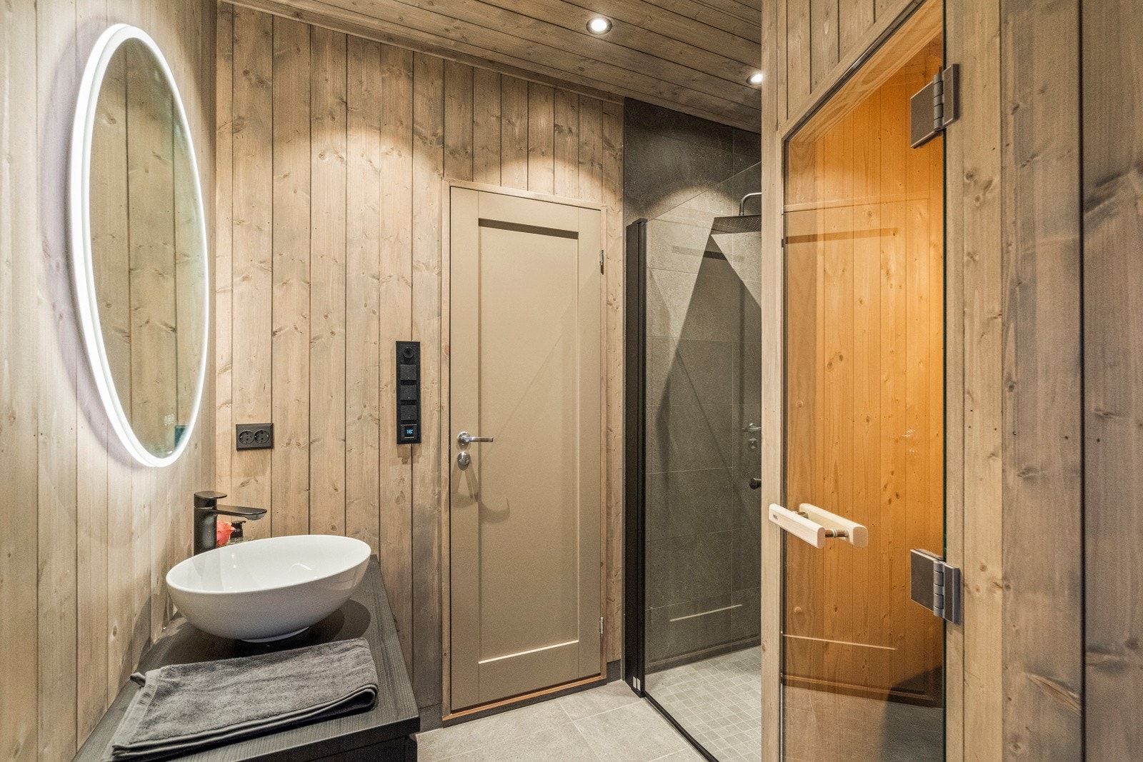 Rommet har innredning med benk m/vask og speil, vegghengt dusj med dør i herdet glass og toalett. I tilknyttning til badet har du en badstu. Galleribilde