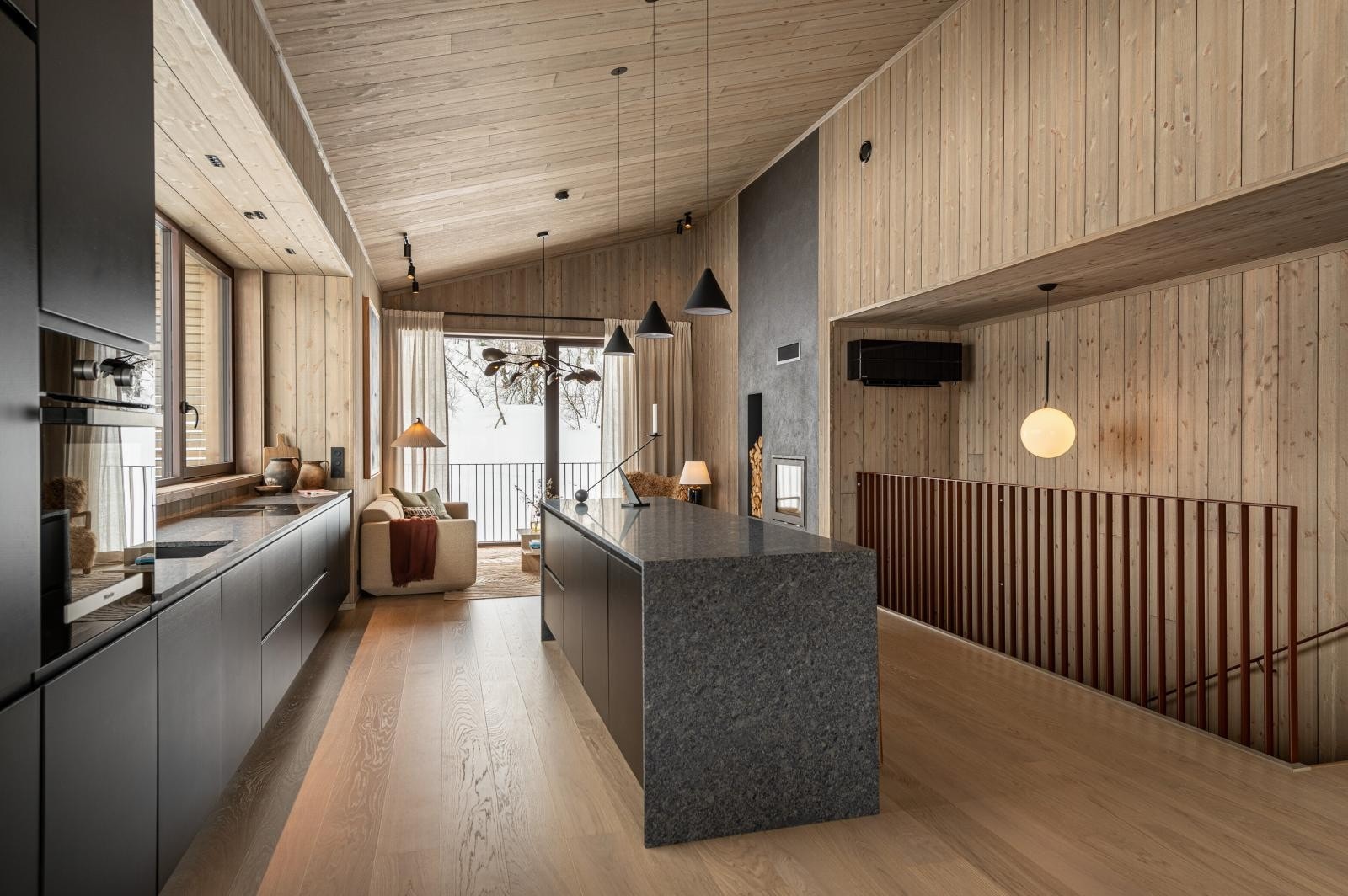 Med den store oppholdssonen hevet opp til 2. etasje, har enheten utsyn til rå natur og samtidig en opplevelse av å være skjermet for omgivelsene. Galleribilde