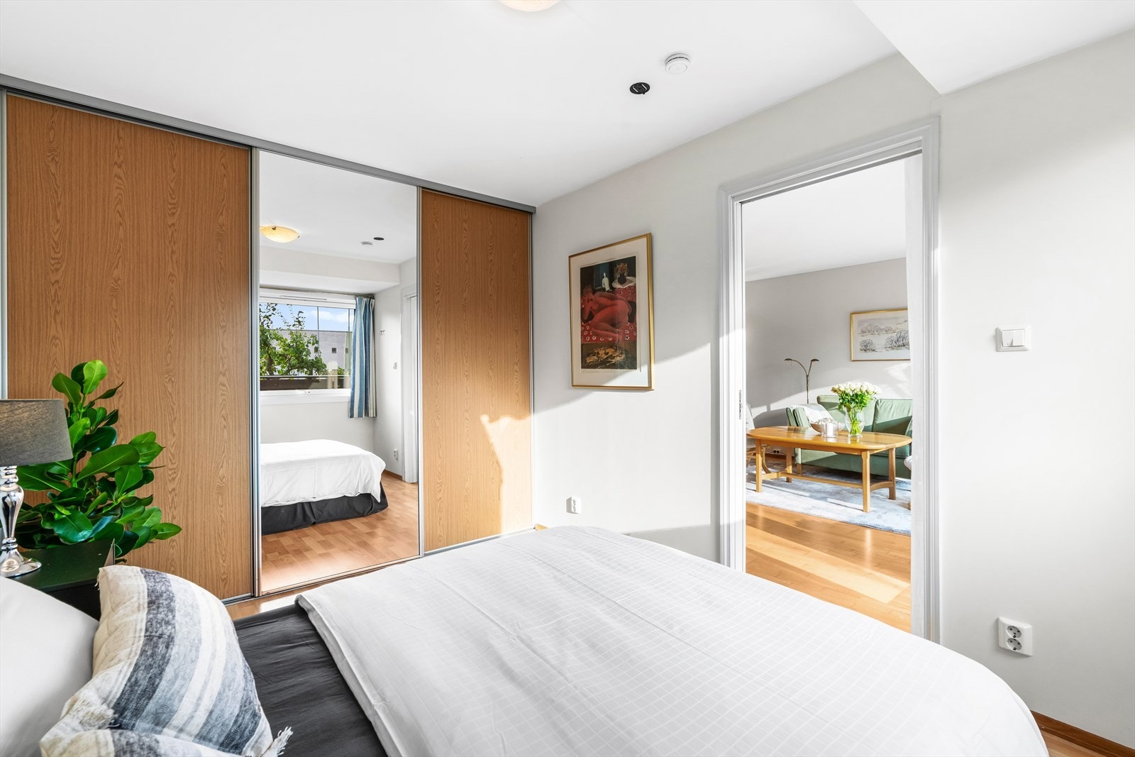 Rommet har gode oppbevaringsmuligheter for klær i en romslig skyvedørsgarderobe Galleribilde