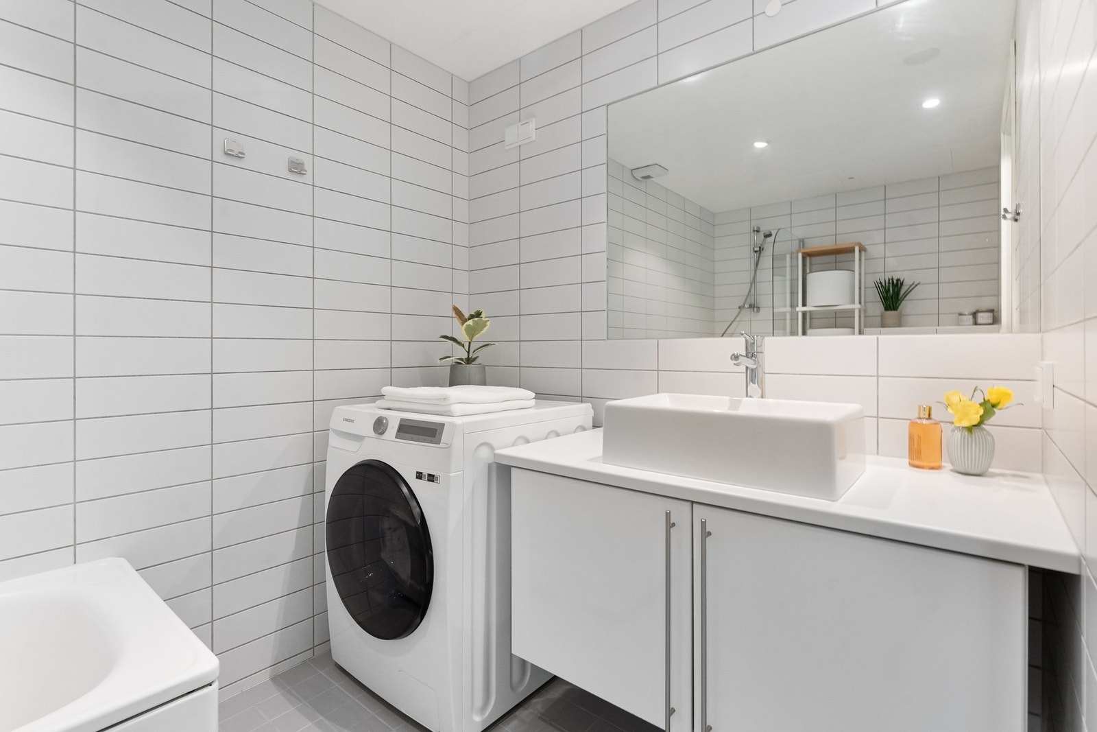 Innredningen består av ovenpåliggende servant på underskap og et stort speil. Baderommet har opplegg for vaskemaskin. Galleribilde