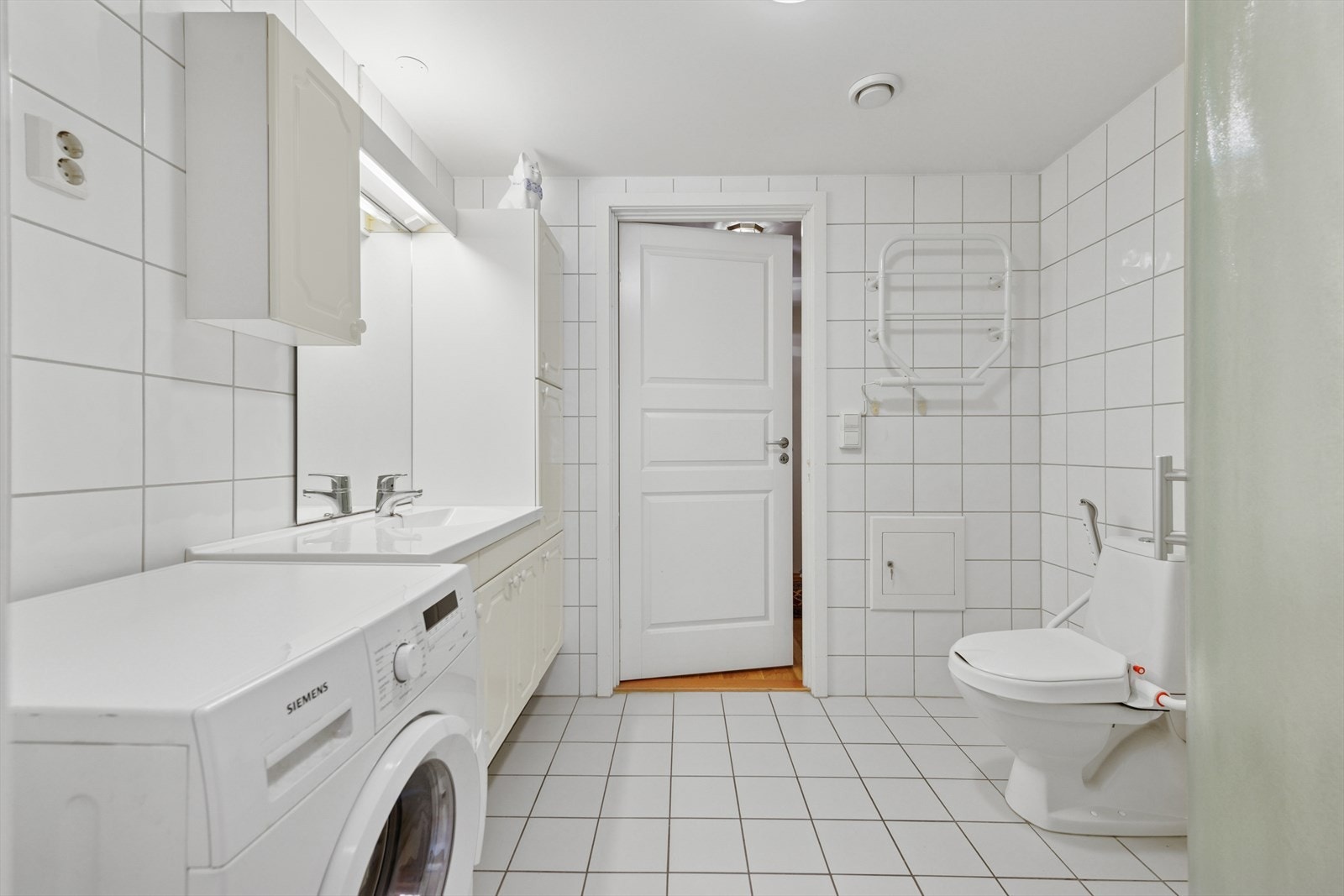 Praktisk flislagt bad med adkomst fra entré og med god tilgang fra hovedsoverommet. Galleribilde