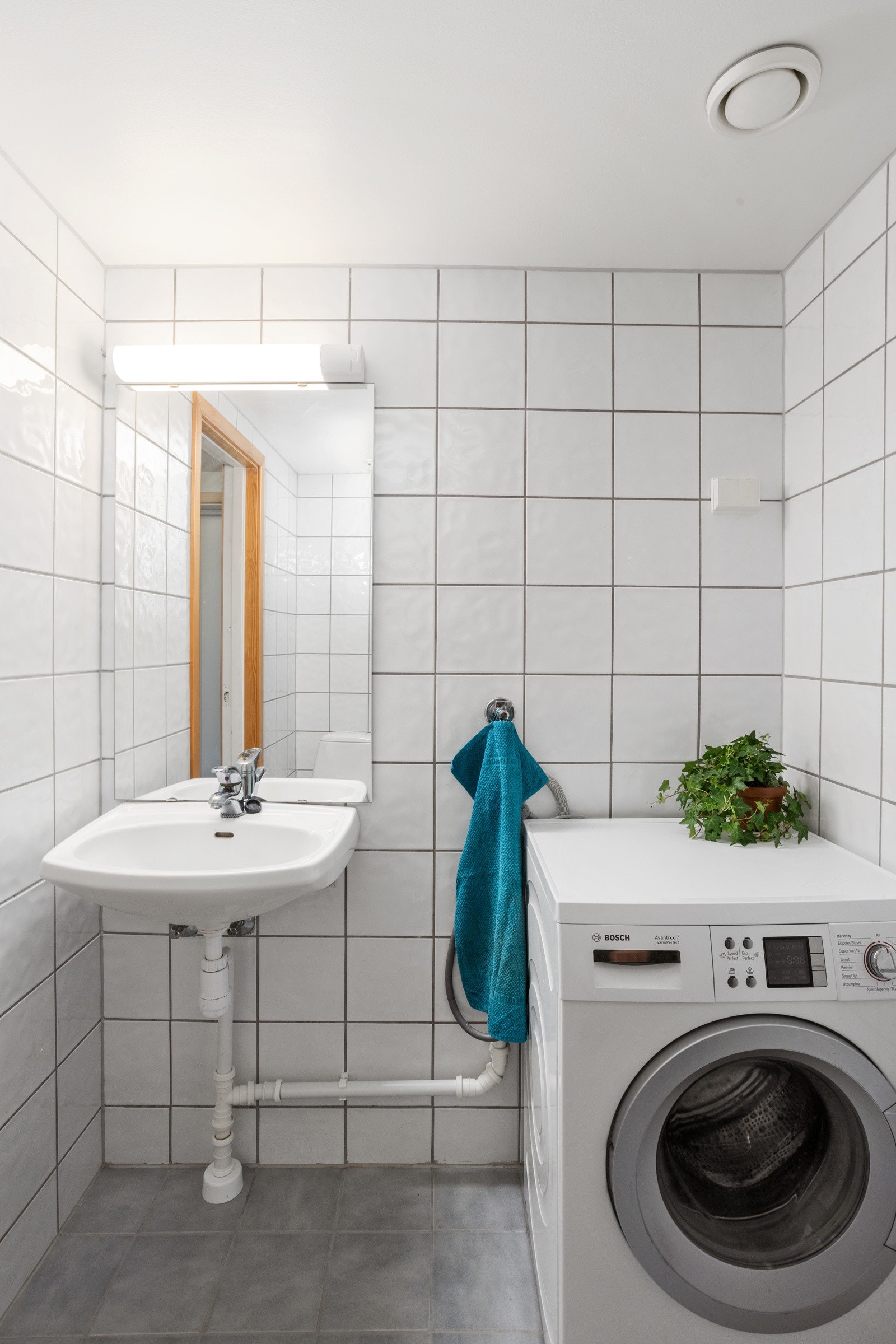 Flislagt bad med varmekabler og opplegg til vaskemaskin. Galleribilde