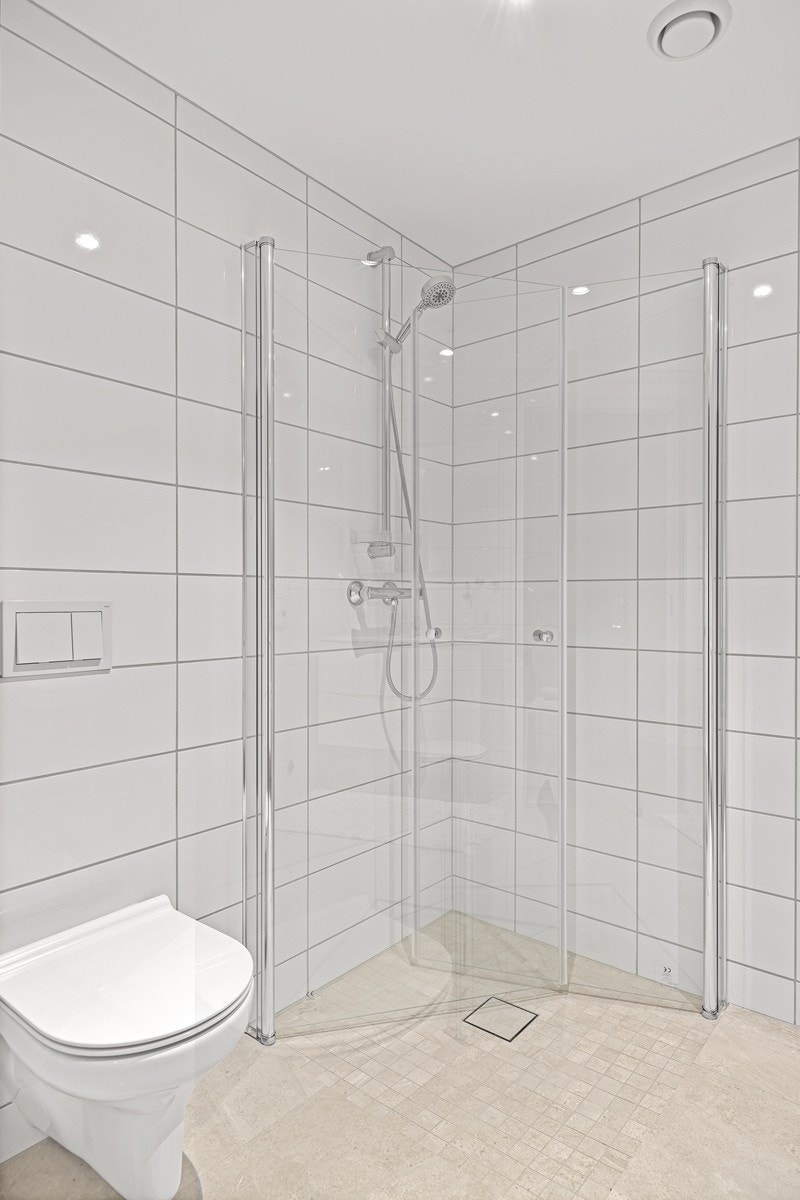 Badet har vegghengt toalett og dusjnisje med innfellbare dører. Galleribilde