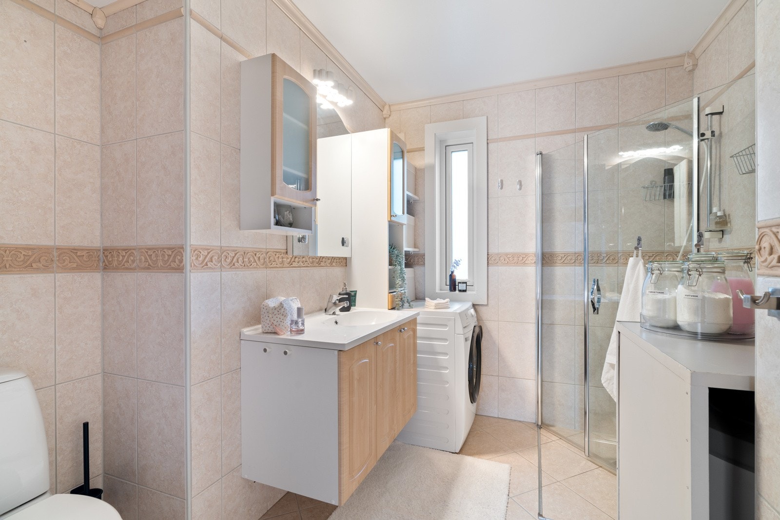 Badet er videre utstyrt med dusjhjørne med innfellbare dører, toalett og opplegg for vaskemaskin. Galleribilde