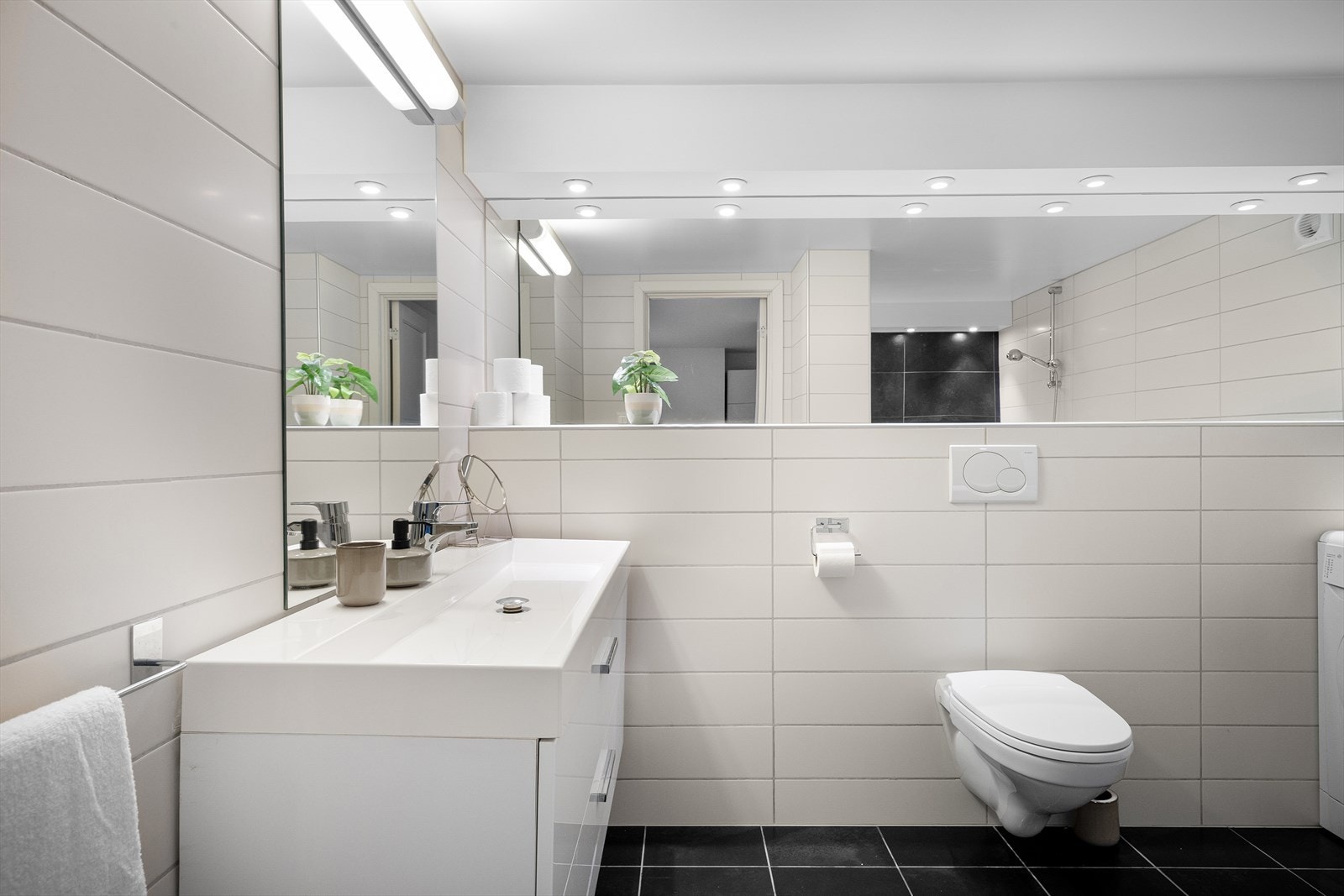 Servant med skuffer, masse hylleplass med speil og vegghengt wc gjør det enkelt å holde rent og ryddig. Galleribilde