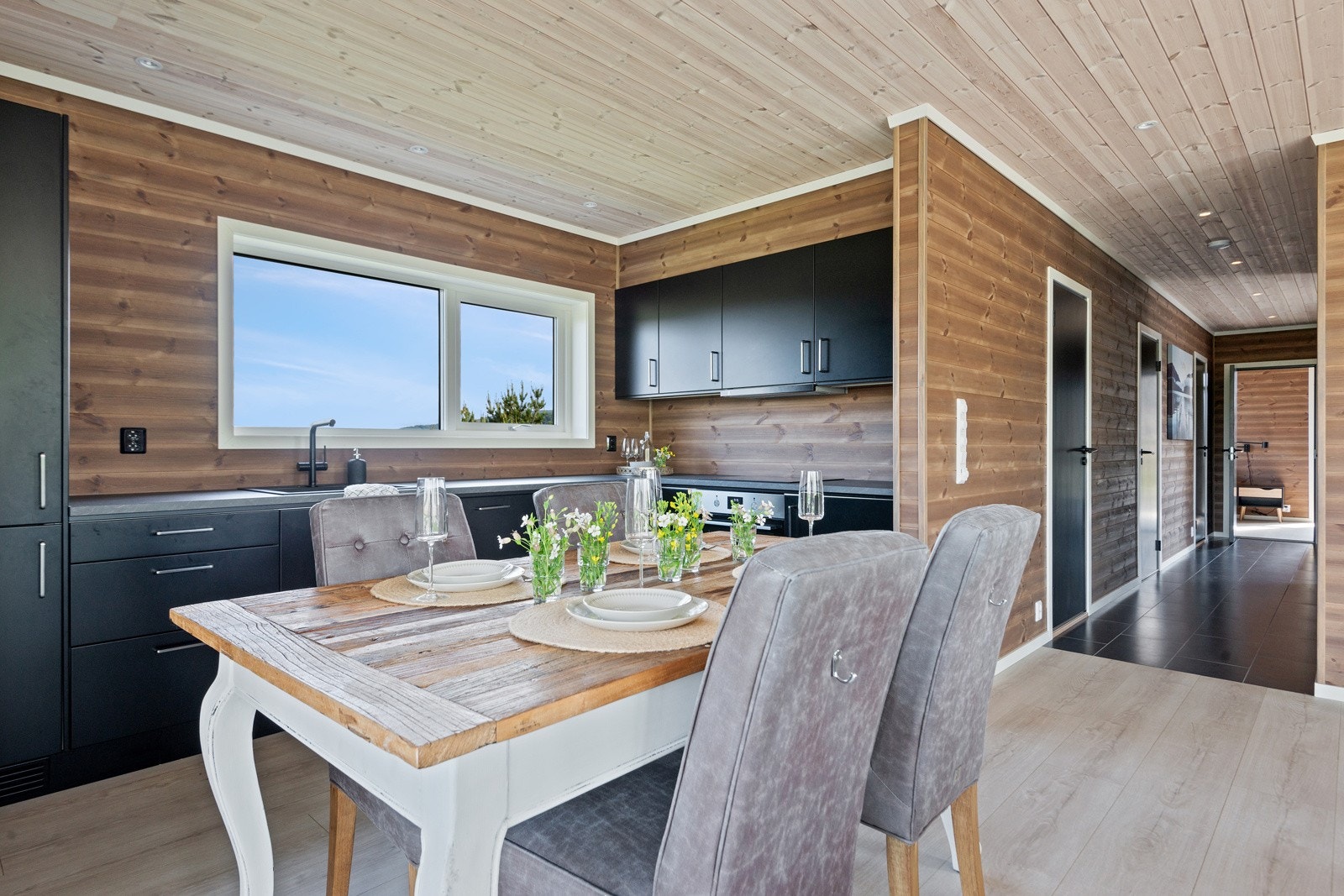 Frå kjøkenbenken så kan einn nyte utsikta utpver nærområdet og ned mot vatnet på nedsida av hytta. Galleribilde