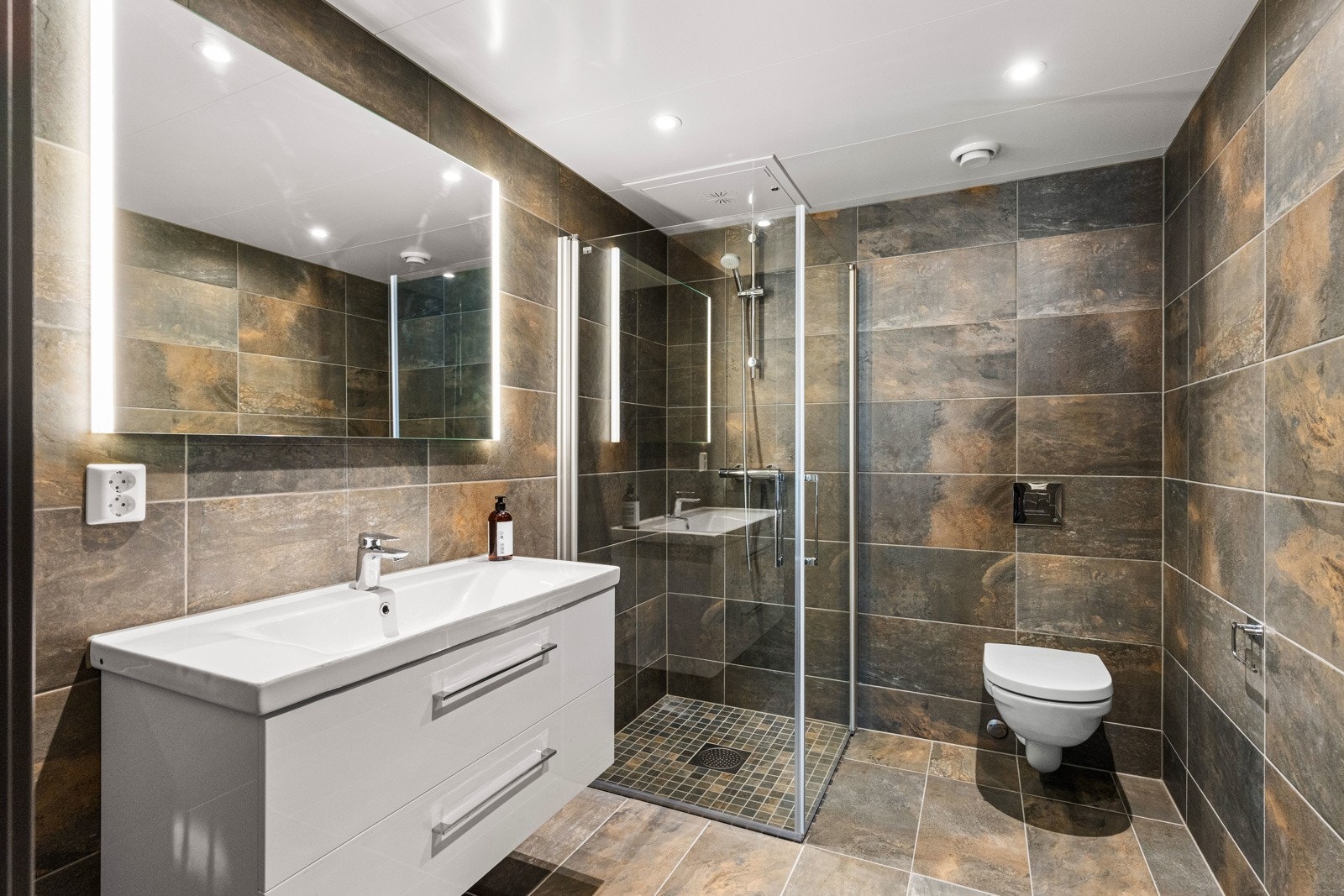 Hovedsoverommet har et eget og delikat baderom. Badet er en perle av mørkt design og detaljer som gir en følelse av luksus og ro. Galleribilde