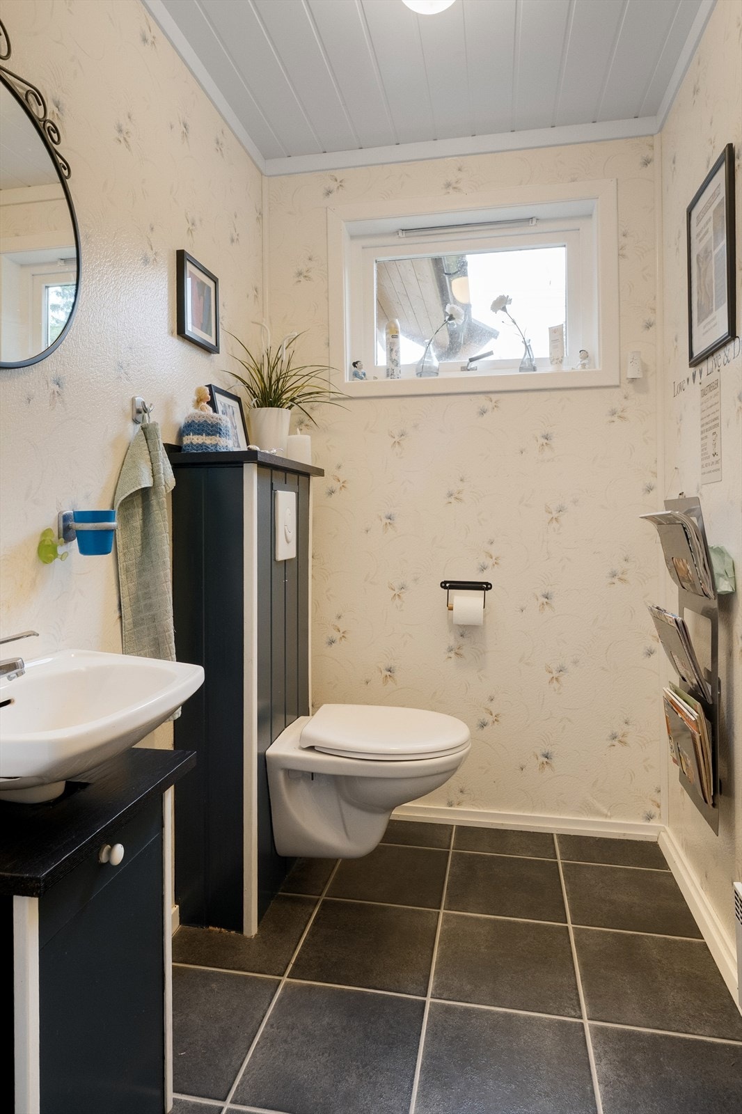 Romslig toalettrom med vegghengt WC og servant. Galleribilde