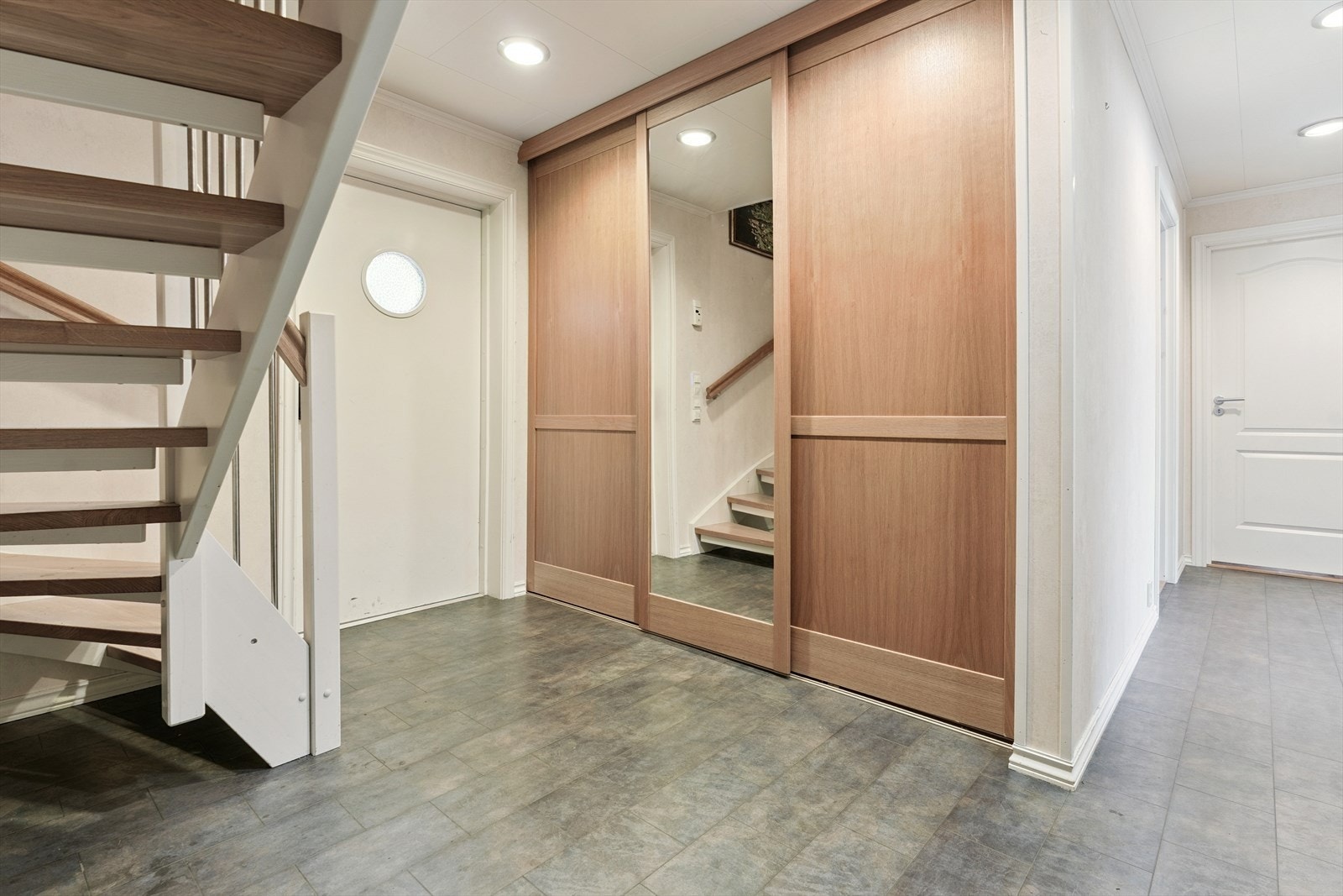 Velkommen inn. Her har du ein lys og triveleg gang med garderobe. Flis på golv og malte plater på vegg. Alle golv i 1.etasje har vassboren golvvarme. Galleribilde