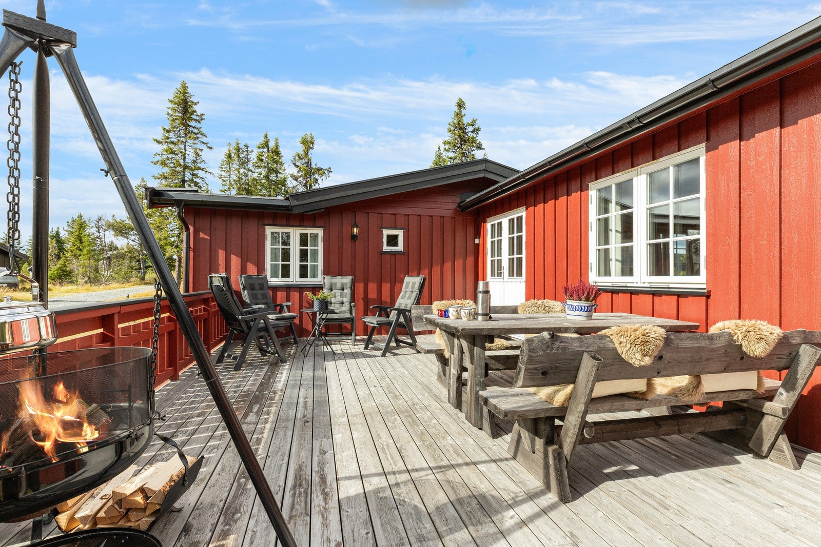 Det er gode solforhold på eiendommen og på de ulike sonene kan man nyte dagen med kaffekoppen, måltider og aktiviteter.
Den største terrassen er åpen og har god plass til sittegruppe og bålpanna Galleribilde