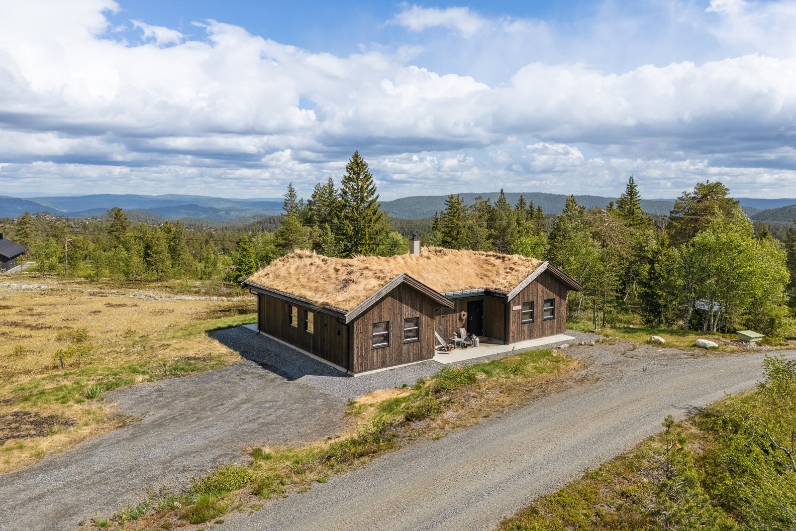 Eiendommen har gruset innkjøring og god plass til parkering på tomten. Galleribilde