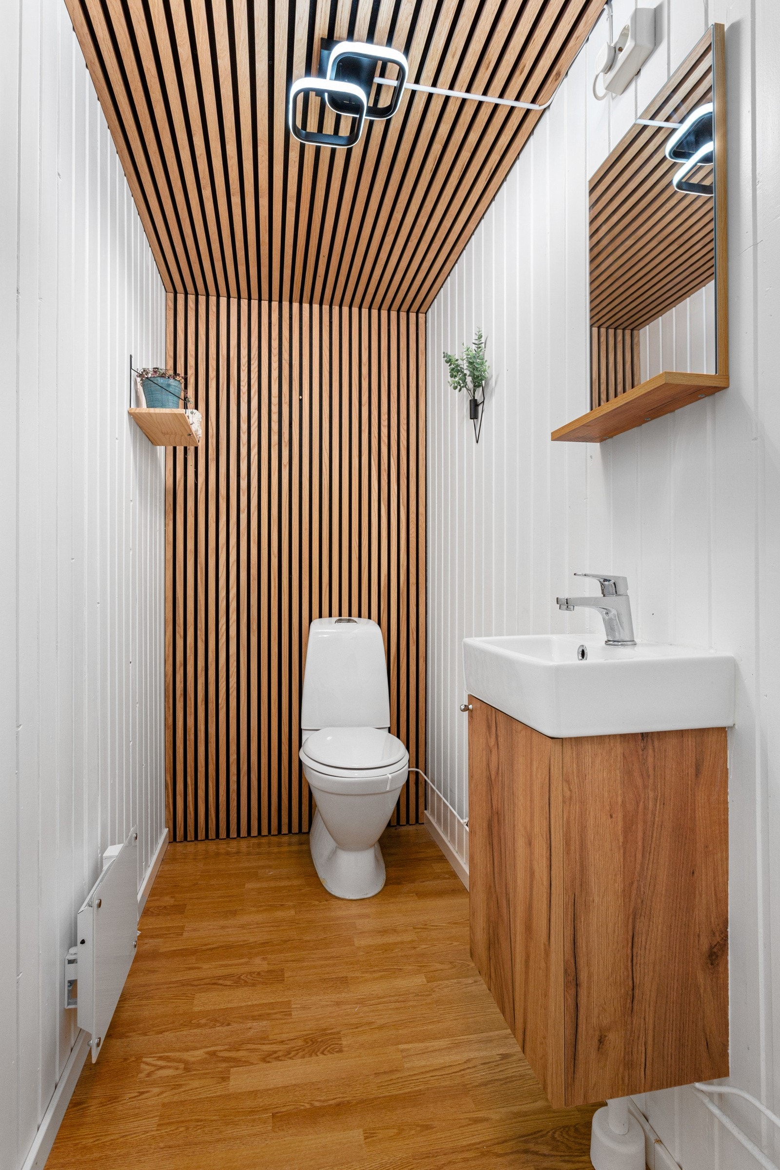 Toalettrommet er plassert ved inngangspartiet og er modernisert med spiler på vegg og himling Galleribilde