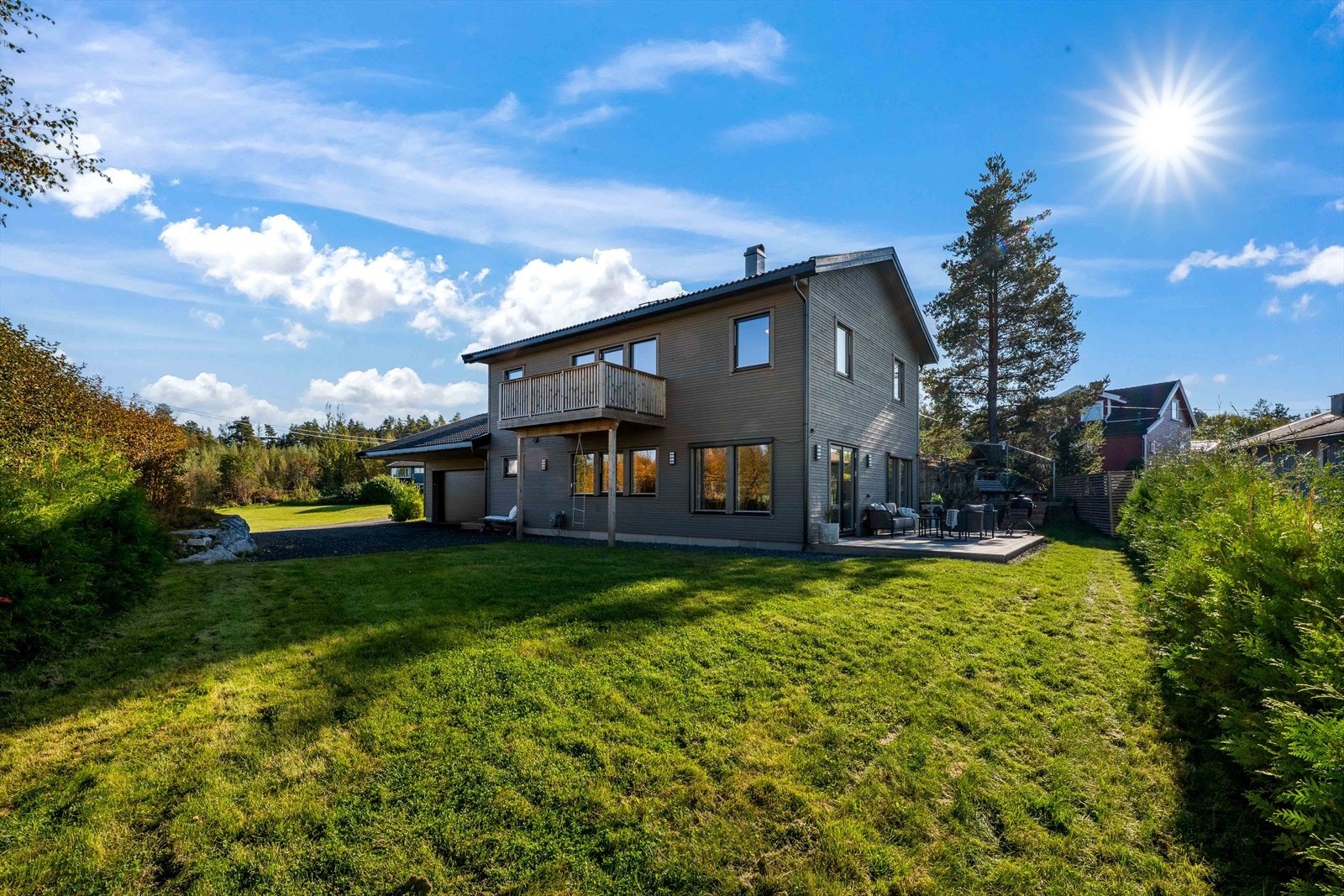 Eiendommen byr på stor tomt på 936 m² med plen, terrasse og gruset gårdsplass. Galleribilde