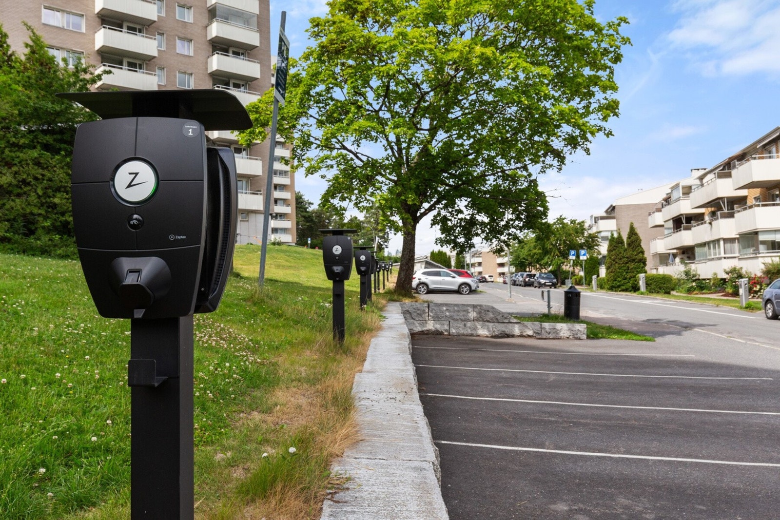 Lademuligheter for elbiler rett utenfor, 16 felles elbilplasser for borettslagets beboere. Borettslaget har oppmerkede parkeringsplasser som benyttes etter "førstemann til mølla"-prinsippet. Galleribilde