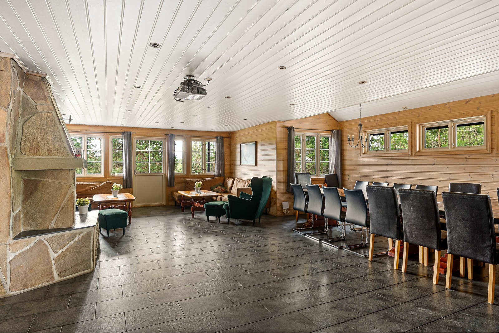 Stor og romslig stue med langbord (plass til 24 personer), sofagruppe fra 2020 og stilig peis. Galleribilde