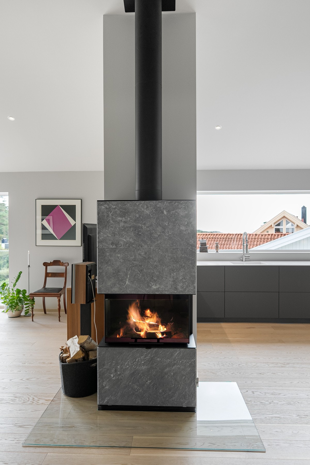 Delevegg og peis skaper et skille mellom stuen og kjøkken/ spisesstue. Galleribilde