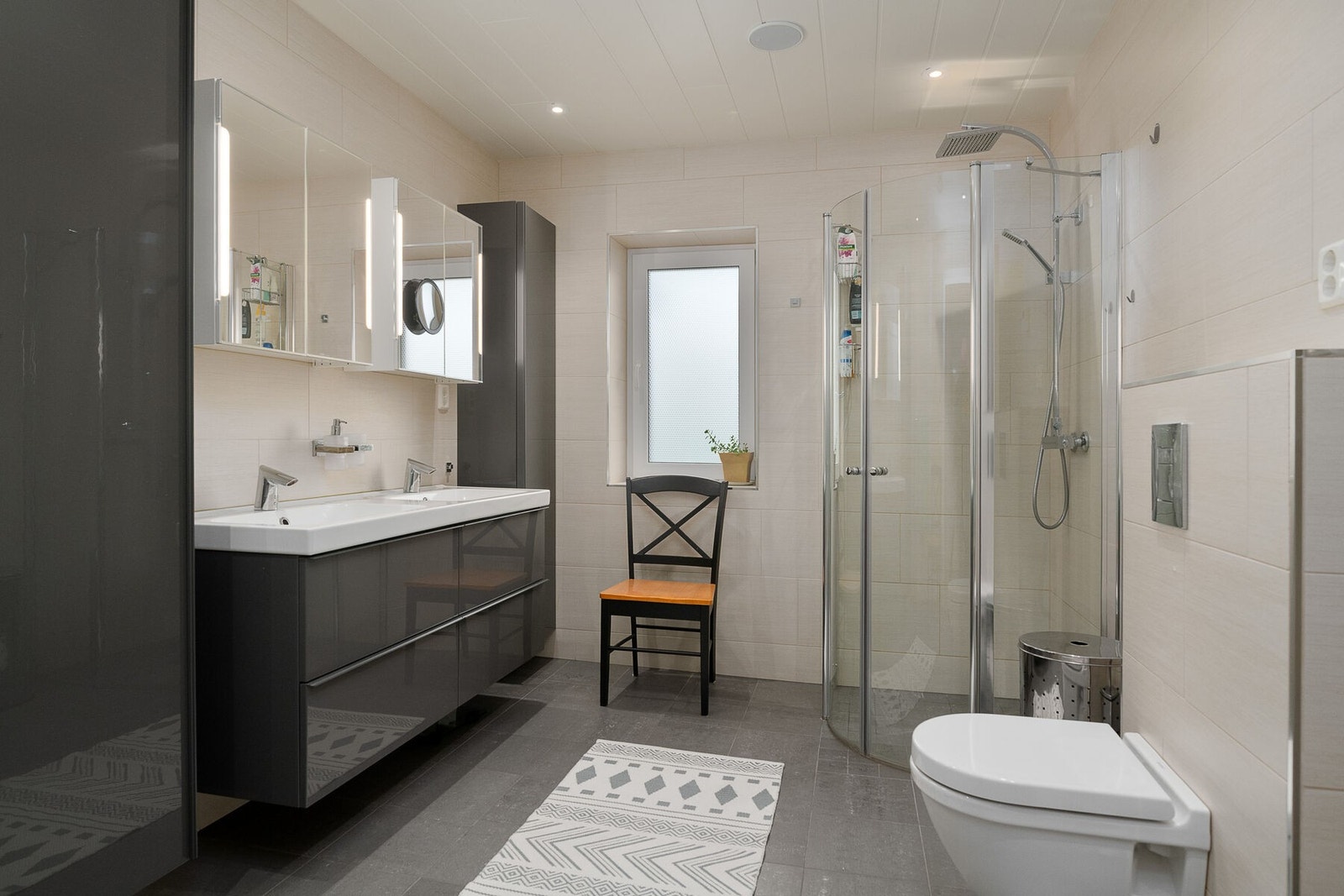 Bad nummer 2 er stilrent utført, med dobbel servant på innredning med skuffer og høyskap, speilskap med belsyning, toalett og dusjhjørne. Det er vannbåren gulvvarme. Galleribilde