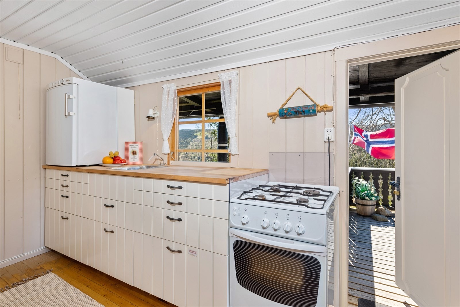 Pent kjøkken med romslig innredning og med gass hvitevarer. Galleribilde