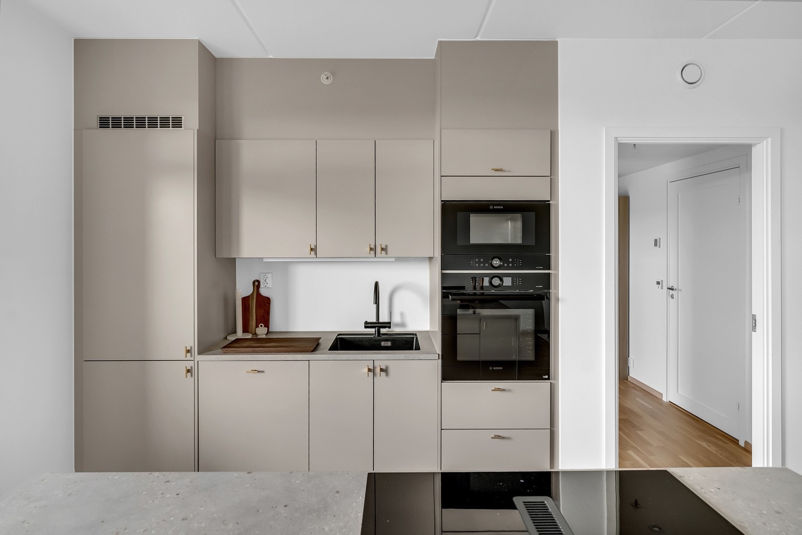 Kjøkkenet har integrerte hvitevarer og en praktisk kjøkkenøy. Galleribilde