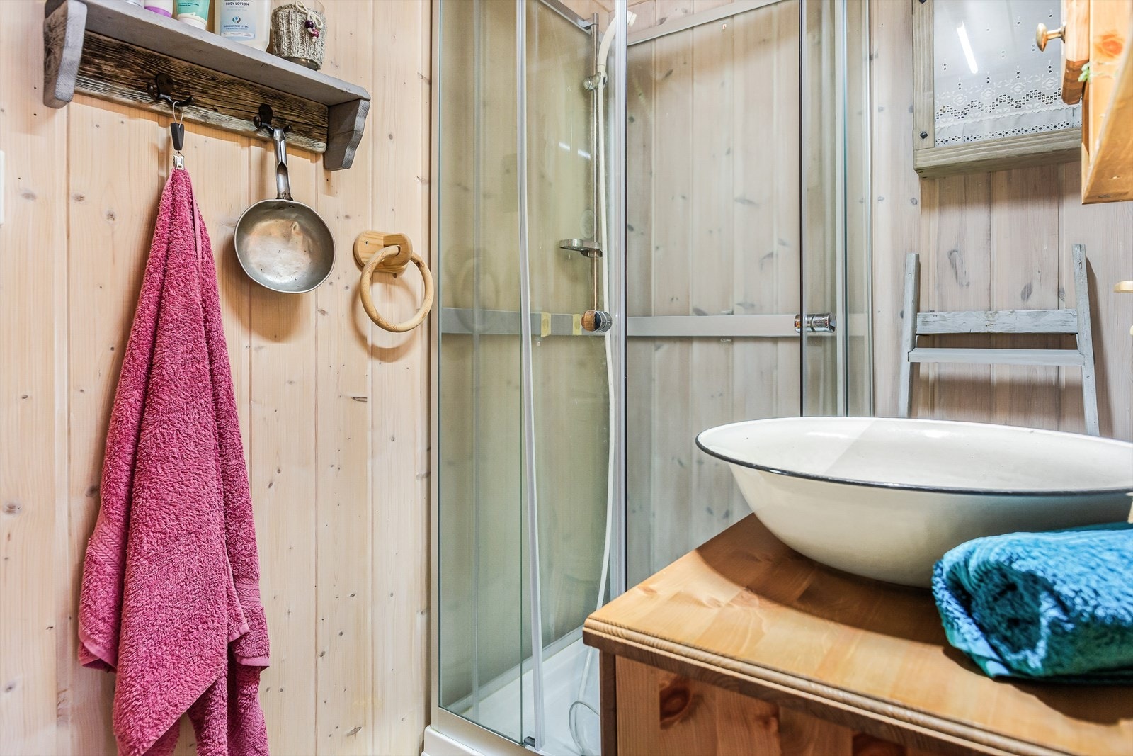 Hytta har et enkelt hyttebad med baderomsinnredning i heltre og frittstående dusjkabinett. Galleribilde