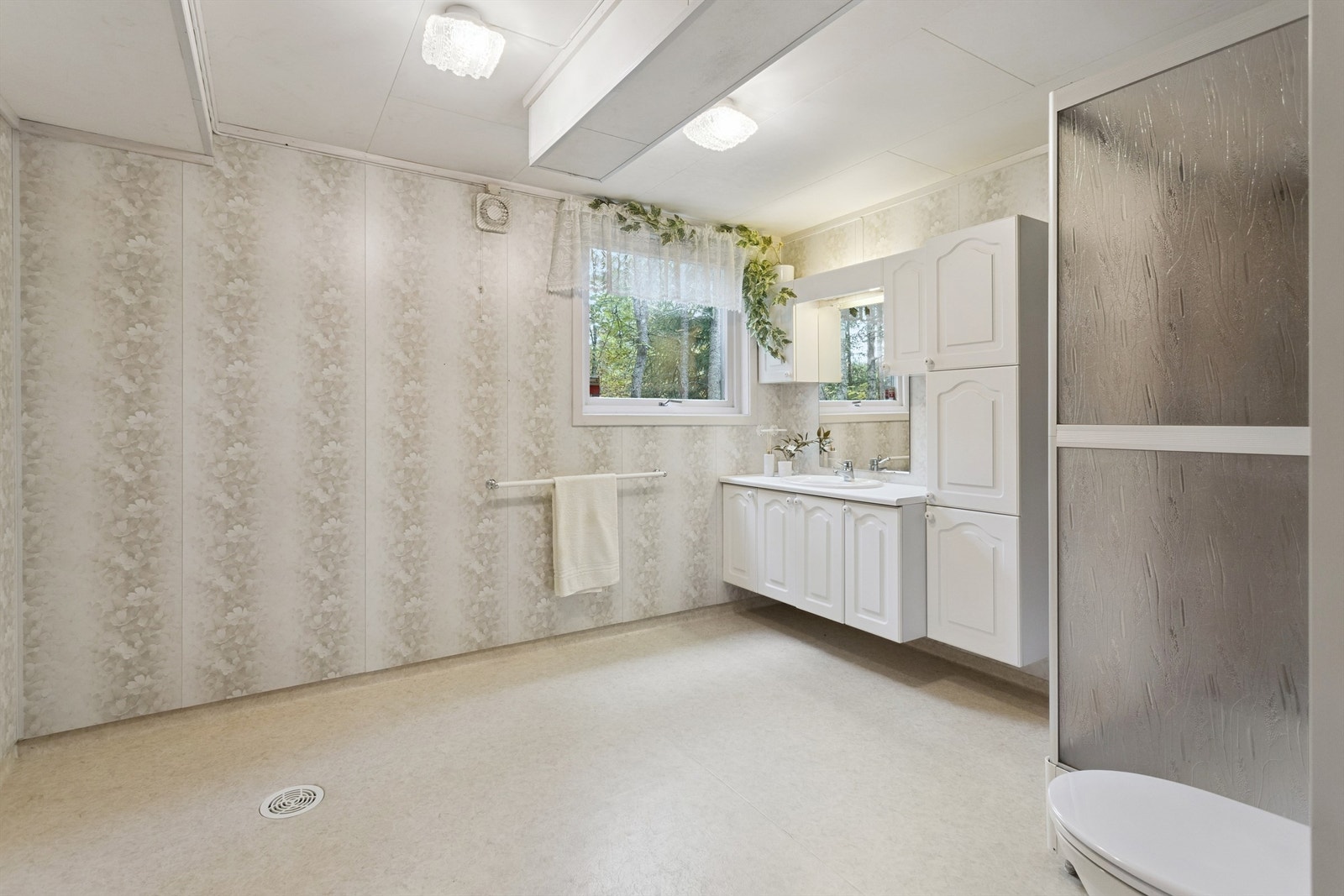 Baderommet i kjelleren er utstyrt med dusjkabinett, og det er gulvvarme for ekstra komfort. Galleribilde