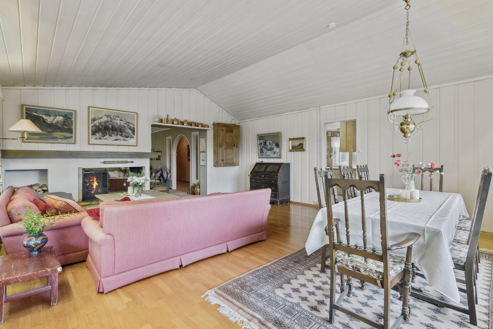Fra spisestuen har man en fin oversikt over stuen og peisen, noe som understreker de sosiale kvalitetene ved rommet. Galleribilde