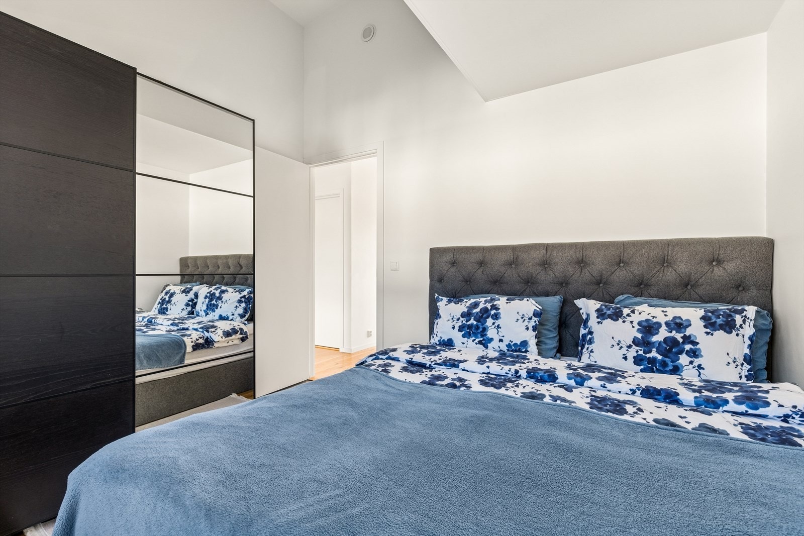 Lyst og rolig soverom med plass til dobbeltseng og garderobeskap Galleribilde