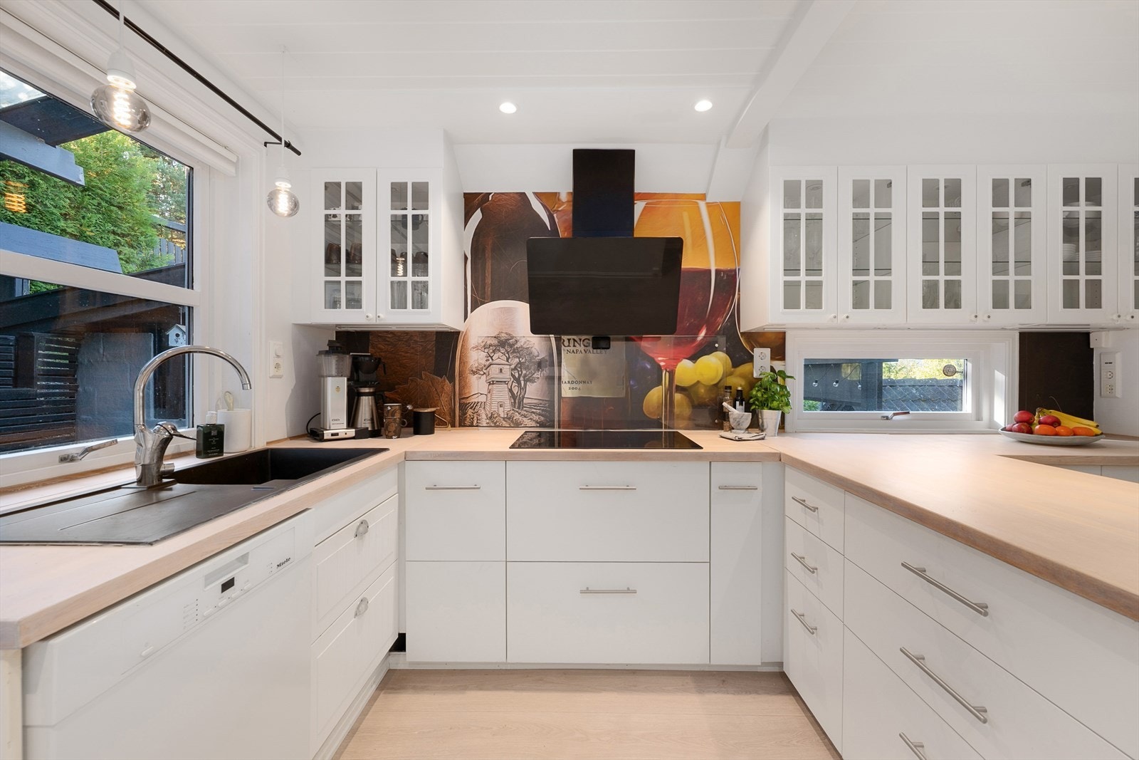 Kjøkkenet er i en u-form med skuffer og skap for oppbevaring. Integrerte hvitevarer. Fint lys inn over benken gjennom vinduer på 2 vegger. Galleribilde