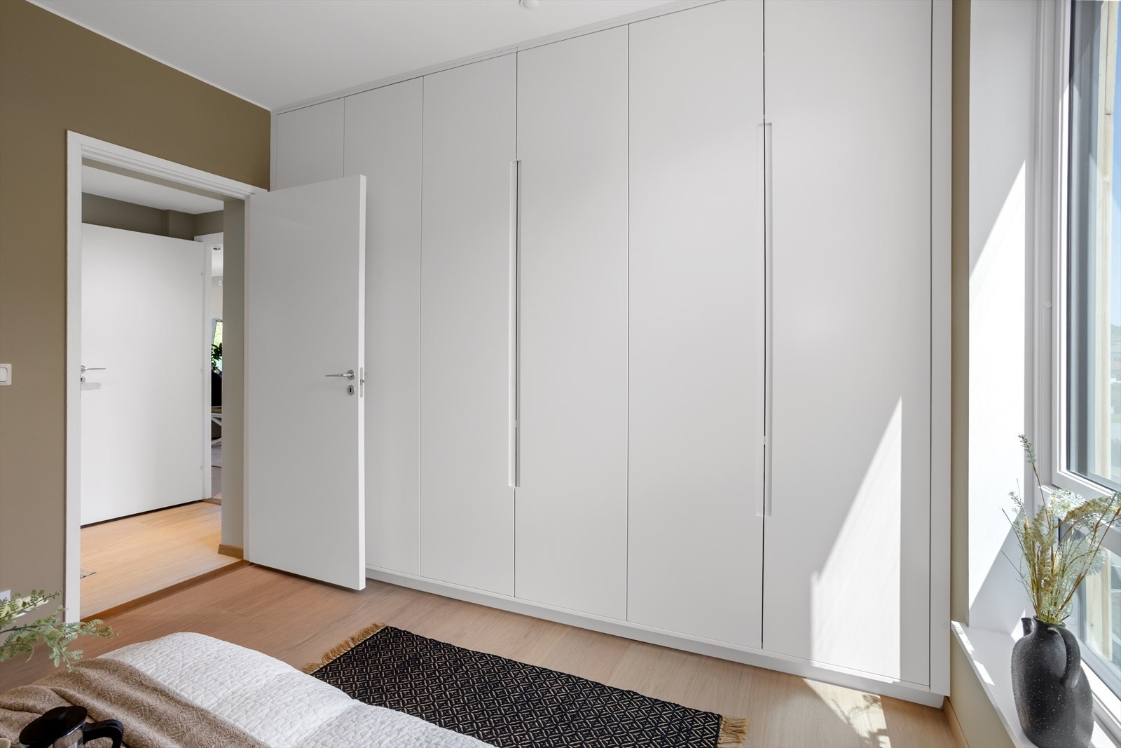 Et av soverommene er påkostet med garderobskapsrekke på hele langveggene i rommet -samtlige med integrerte hyller, hengeanordninger og skuffer. Galleribilde