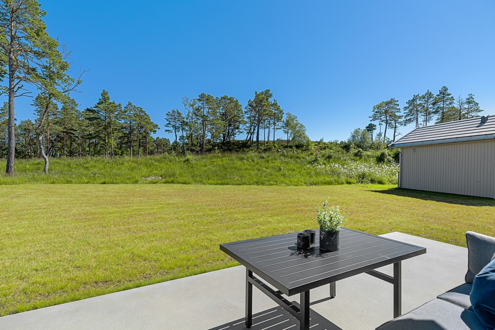 Stor plen, ideell til ballspill og lek. Mulighet for å sette opp uthus/anneks med stue, soverom og bad Galleribilde