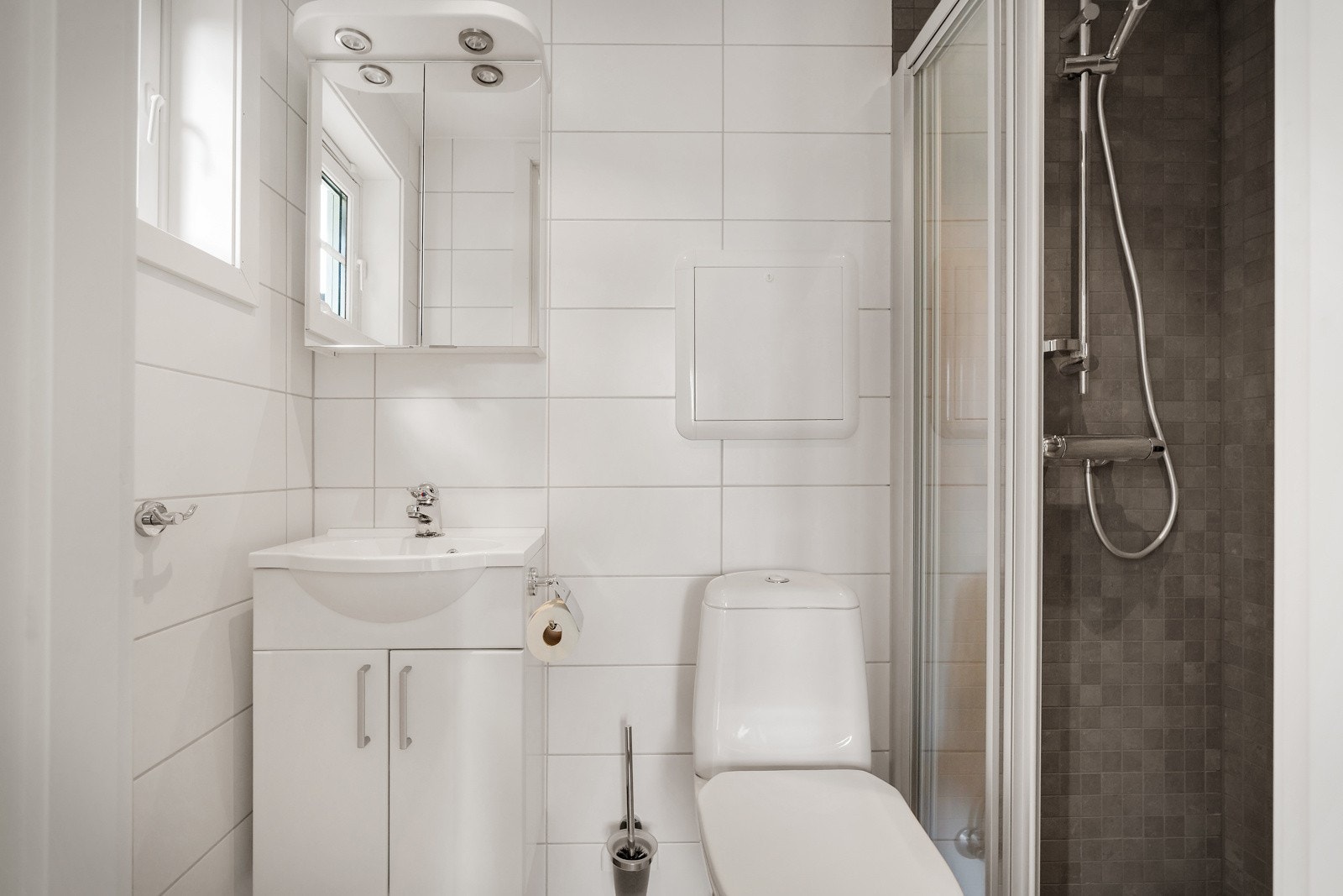 - Her har man helfliset bad med varmekabler, toalett, dusjnisje med glass skyvedør, servant med møblement, speil og belysning - Galleribilde