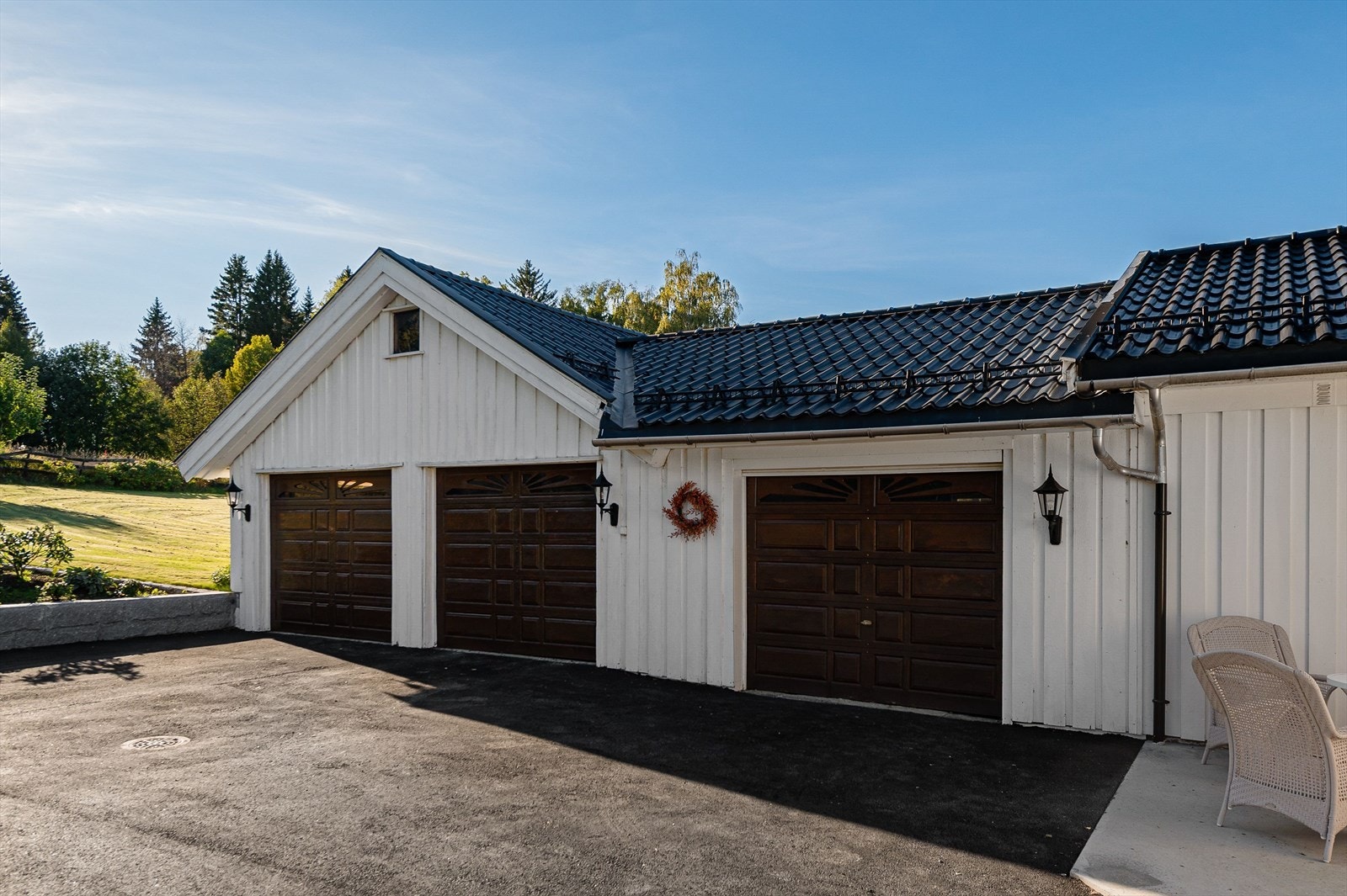 Stor garasje med tre biloppstillingsplasser og praktiske boder. Galleribilde