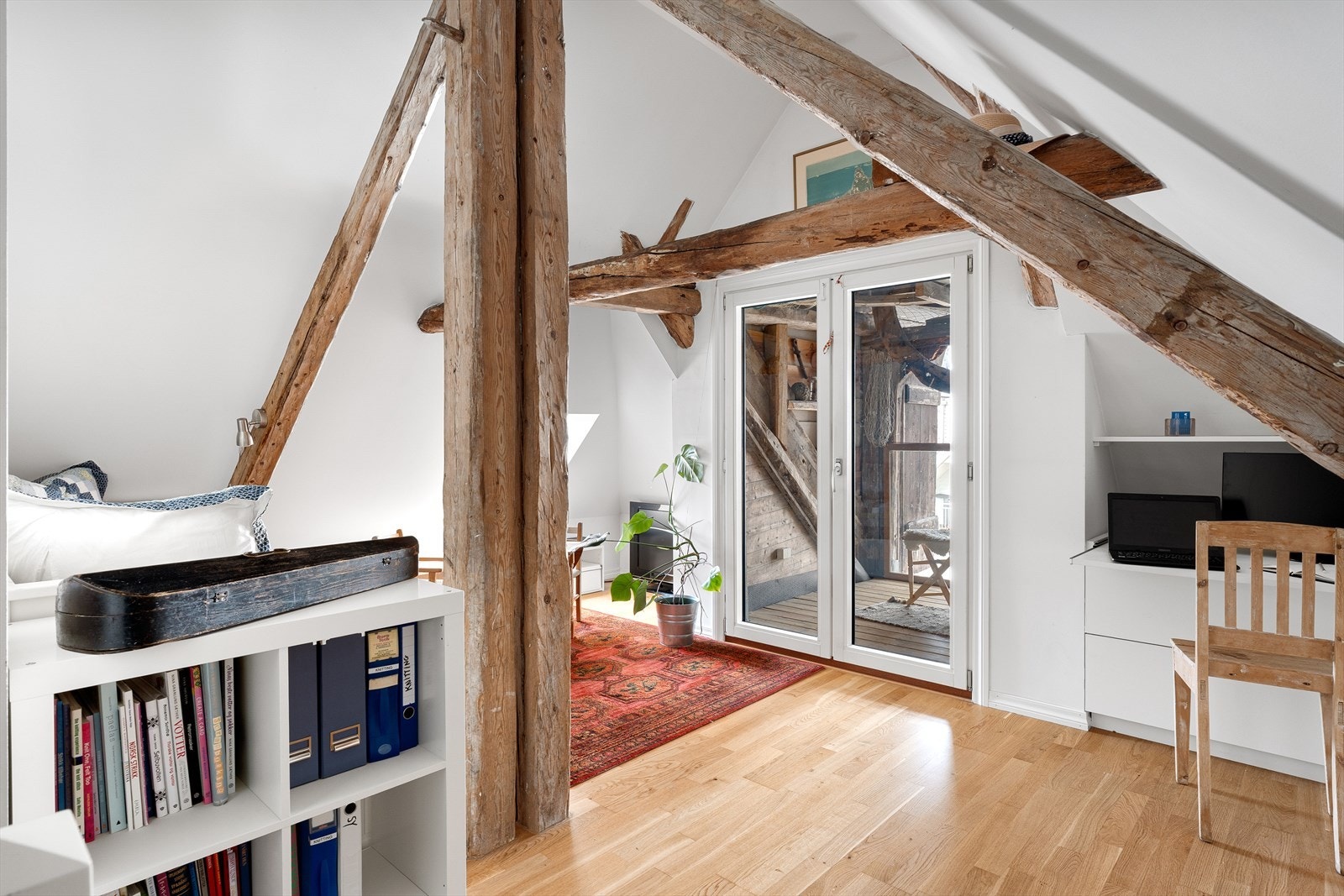 Loftsstue med plassbygd kontor og plass til sittegruppe i tillegg til annen innredning. Galleribilde
