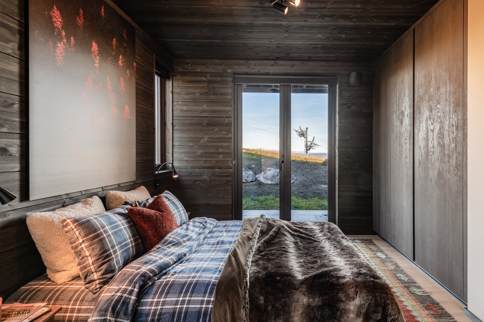 Begge soverommene er utstyrt med smakfulle, integrerte garderobeskap som harmonerer med hyttens helhetlige stil. Galleribilde