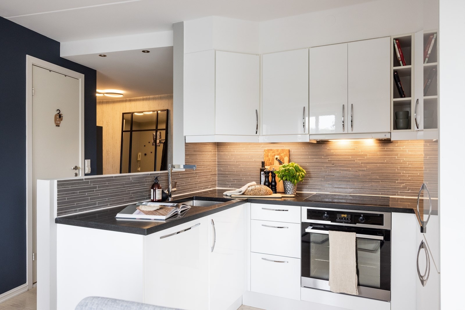 - Kjøkkeninnredning med glatte fronter, benkeplate av stein m/underlimt vaskekum, fliser og belysning - Galleribilde