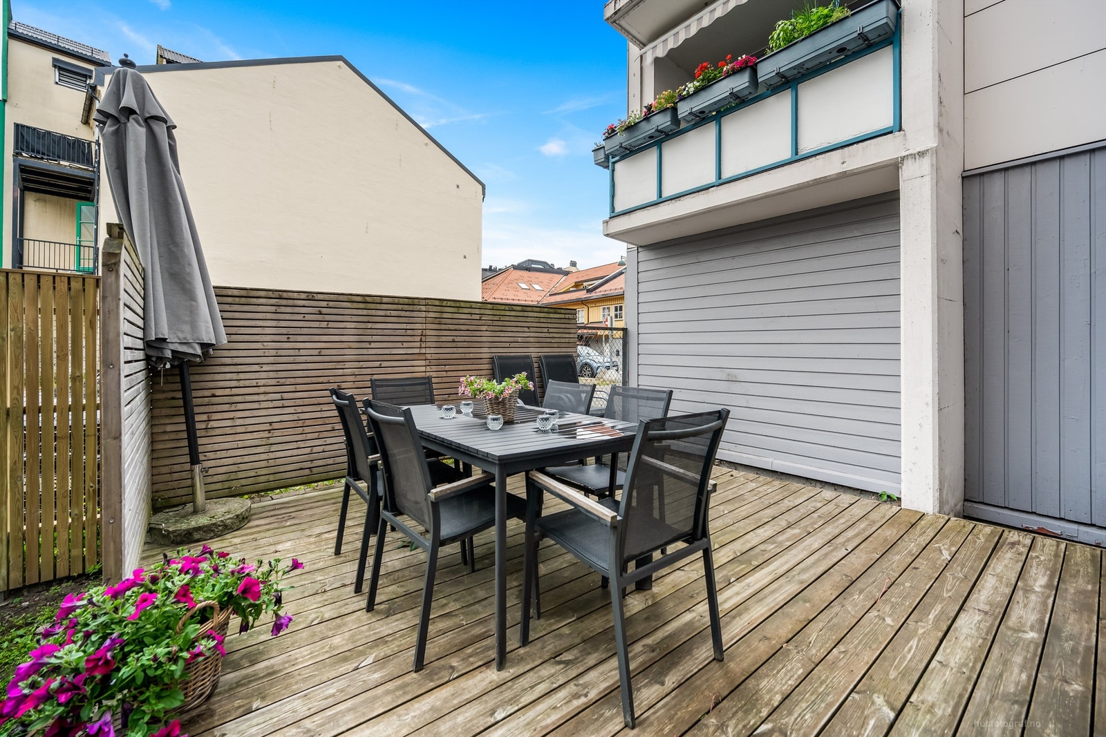 Fellesarealet er opparbeidet med noe gressplen og felles platting med hagemøbler Galleribilde