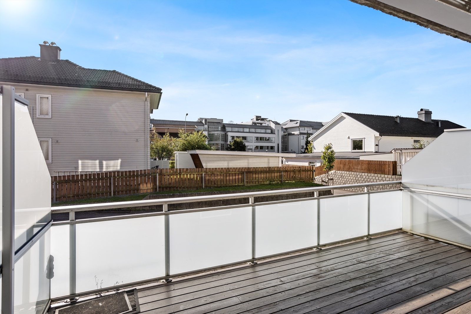 Gulvet på terrassen er av beiset tre, mens rekkverket består av aluminium og frostet glass. Levegger i frostet glass som gir skjerming mot naboterrasse. Galleribilde