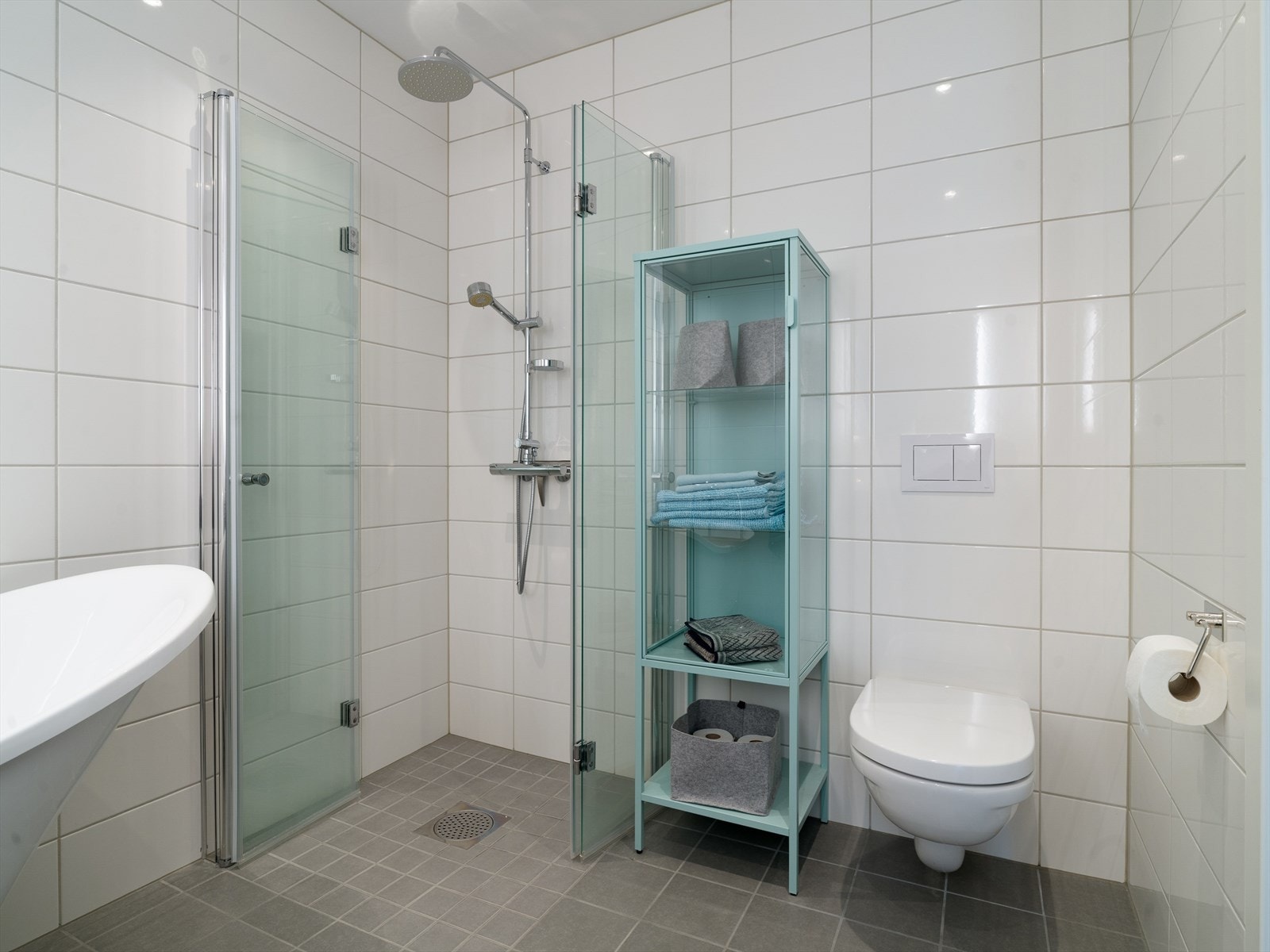 Dusjhjørne med regnfallsdusj. Vegghengt toalett. Downlights i taket. Galleribilde