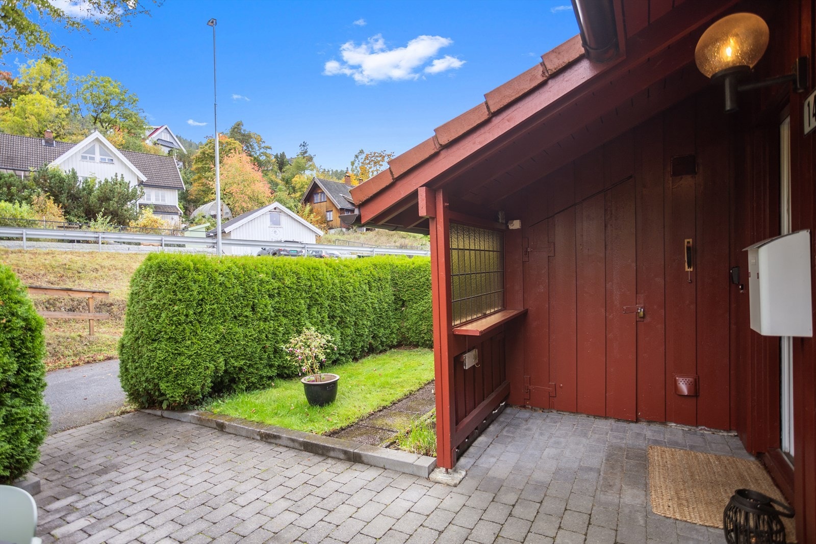 Overbygget inngangsparti og adkomst til den utvendige boden. Ideell for oppbevaring av sykler, hagemøbler og annet utstyr. Galleribilde