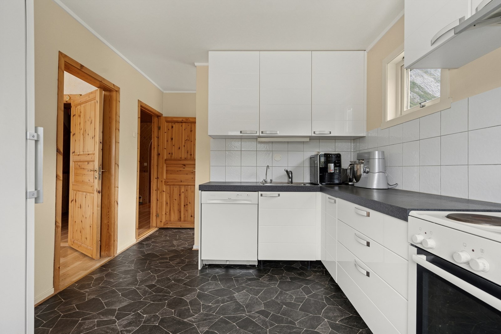 Kjøkkenet i hovedetasjen er godt utbygget med skap og benkeplass. Galleribilde